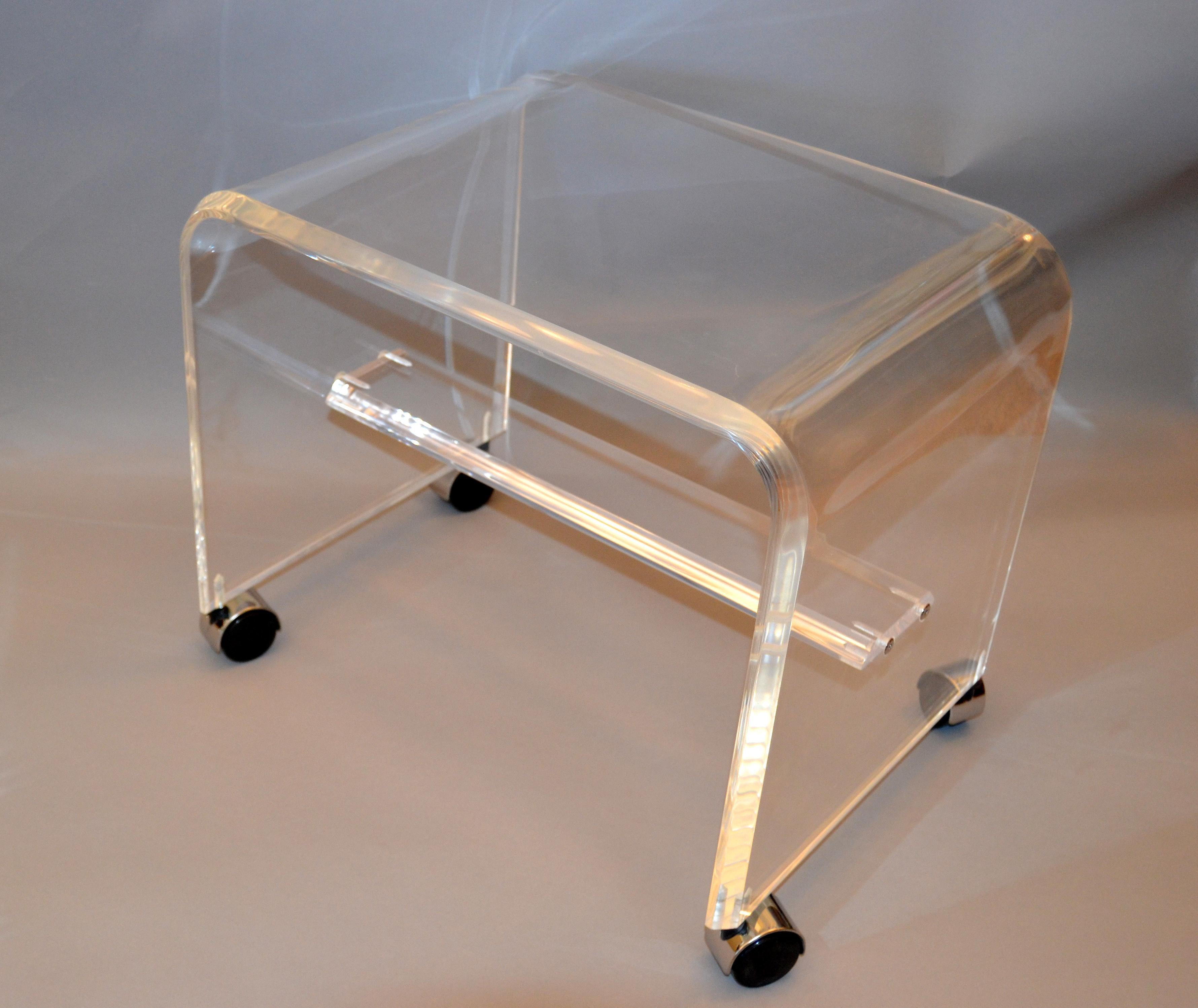 Mid-Century Modern Lucite or acrylic stool on chrome casters.
This stool can be used as a footstool, vanity stool or a place to put your magazine.
The stool is firm and sturdy and ready for your home.
 
 