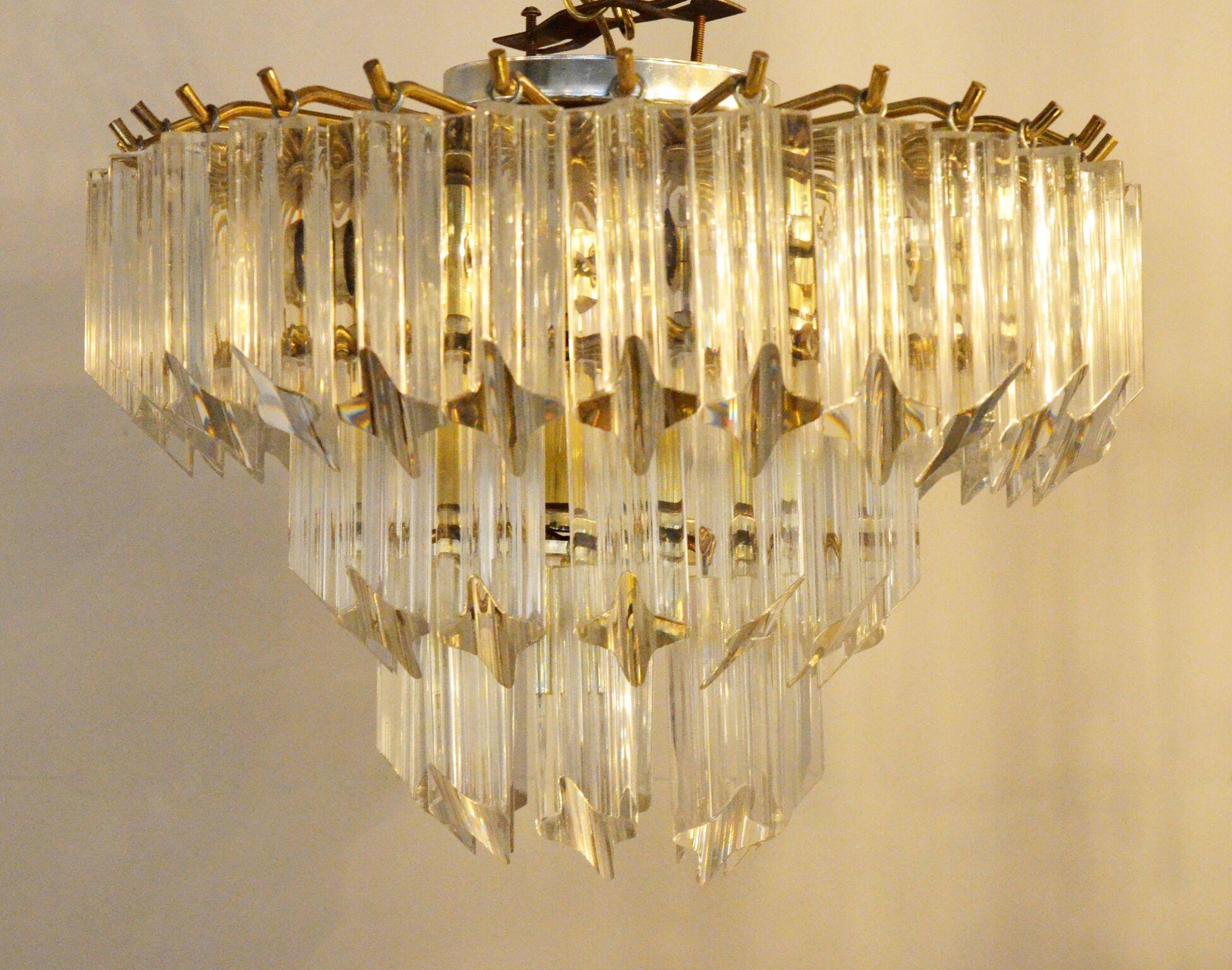 Offered is a Mid-Century Modern hanging lucite triad prisms and brass flushmount 