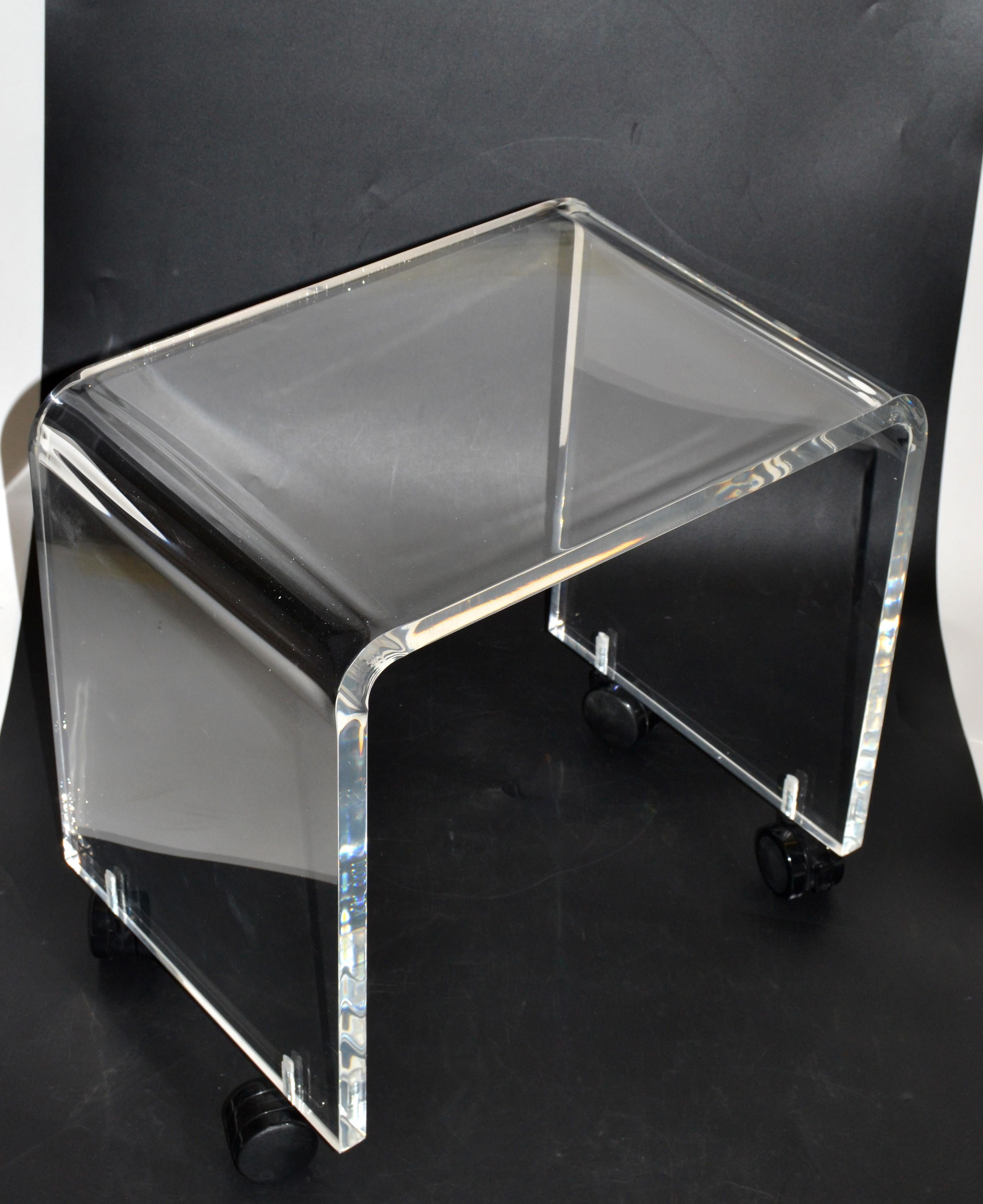 Mid-Century Modern Lucite stool on black casters.
This stool can be used as a footstool, vanity stool or a place to put your magazine.
The stool is firm and sturdy, ready for a new home.
  
