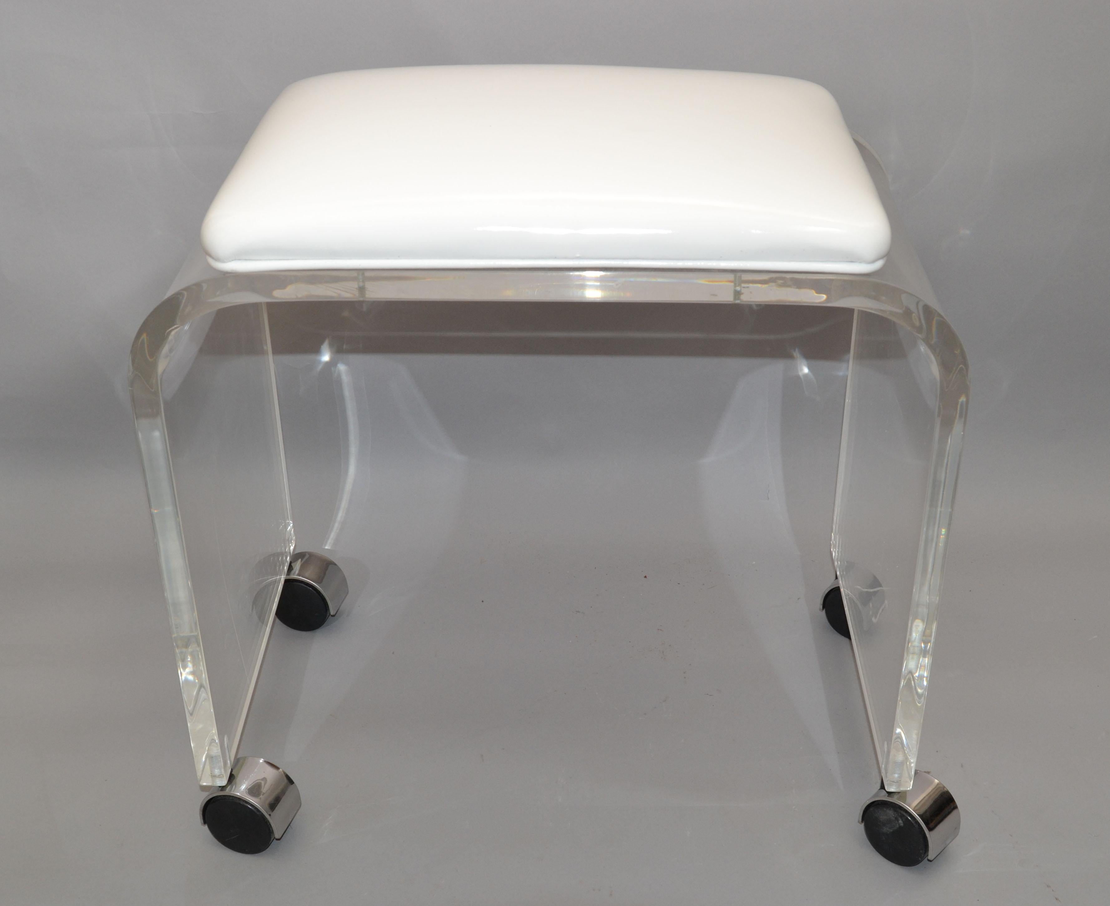 Mid-Century Modern Lucite stool, waterfall bench with white vinyl seat on chrome casters.
This stool can be used as a footstool, vanity stool or a place to put your magazine.
The stool is firm and sturdy, wheels run smoothly and is ready for a new