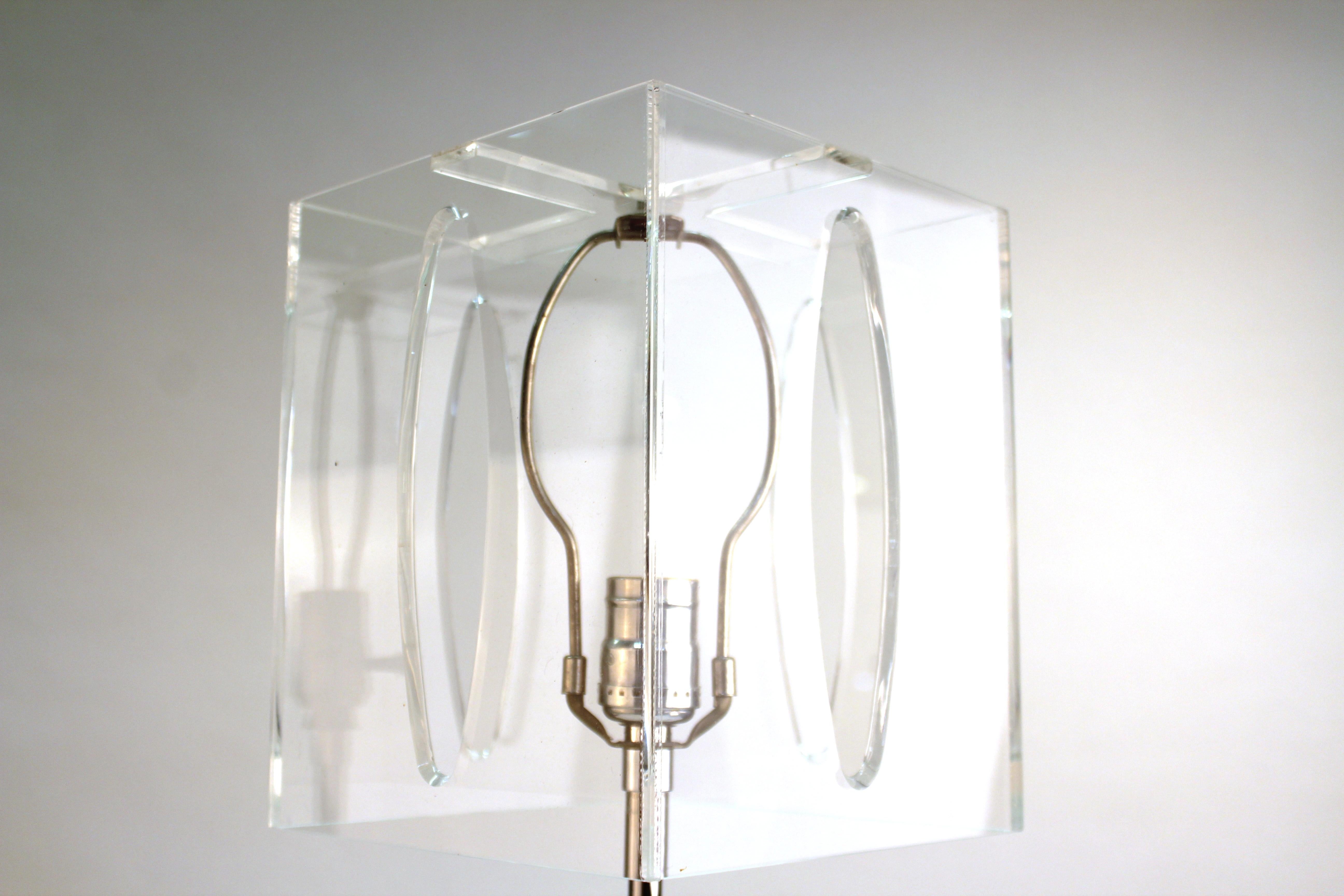 Mid-Century Modern table lamp with a fluted clear Lucite column stem and a perforated square clear Lucite shade. The piece is in great vintage condition with age-appropriate wear.