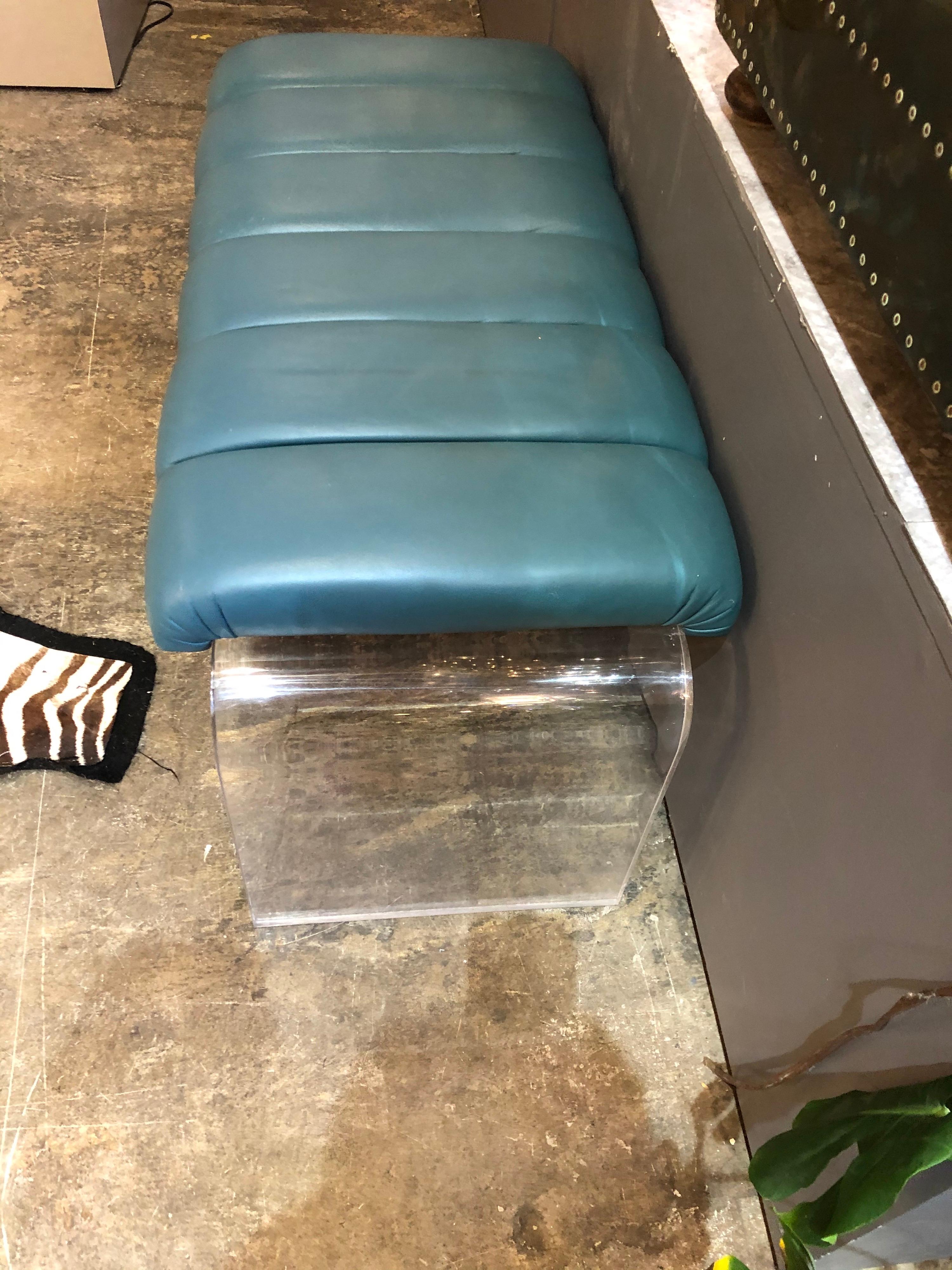 Mid-Century Modern waterfall Lucite bench having a teal tufted leather seat
.
    