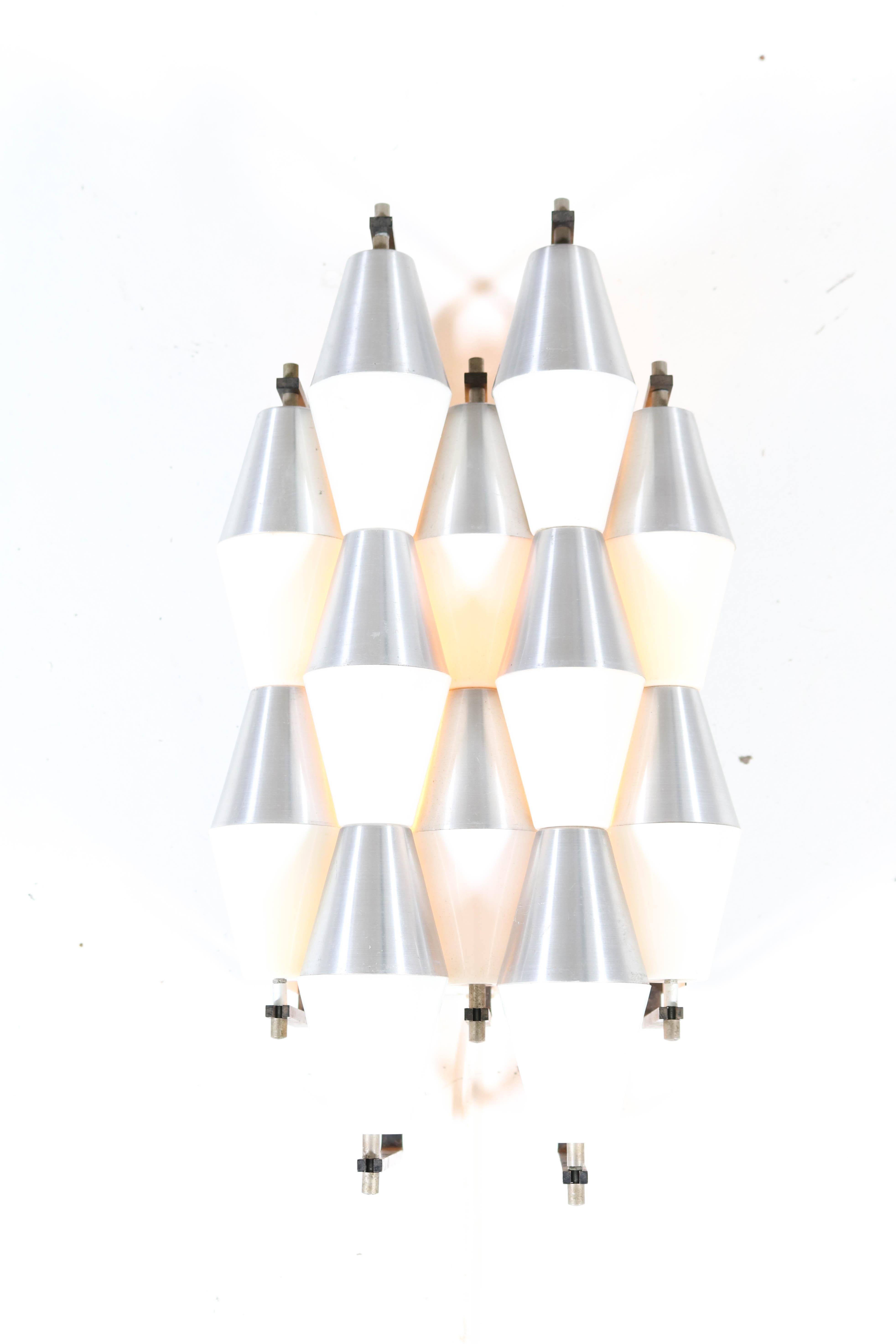 Wonderful and rare Mid-Century Modern wall light or sconce.
Design by RAAK Amsterdam model: Ludiek.
Striking Dutch design from the 1960s.
This combination of plastic and aluminum hoods gives a wonderful effect when lit!
This wall light or sconce