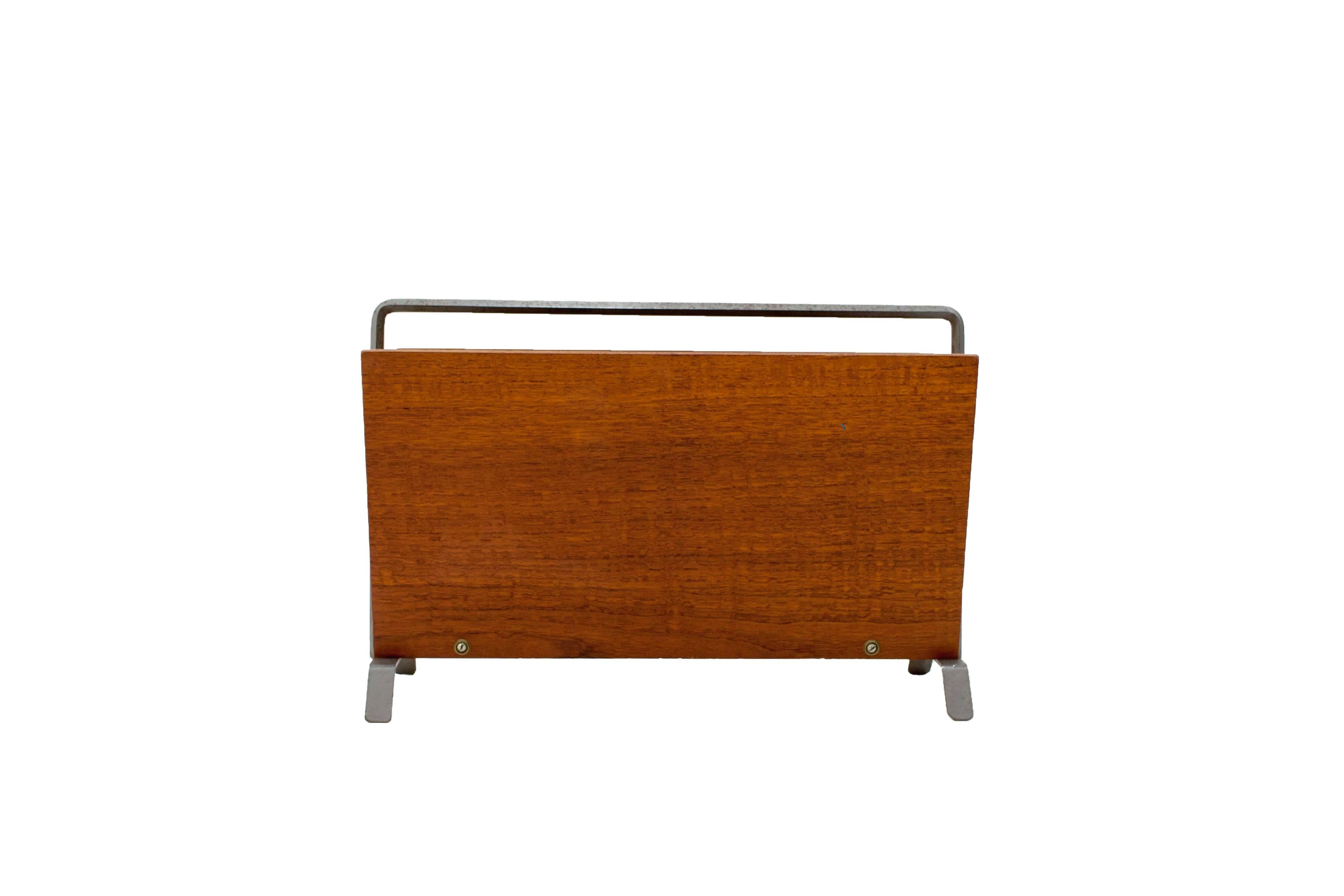 Striking minimalist magazine rack from the early 1960s. Teak with a six-sided bent metal handle.