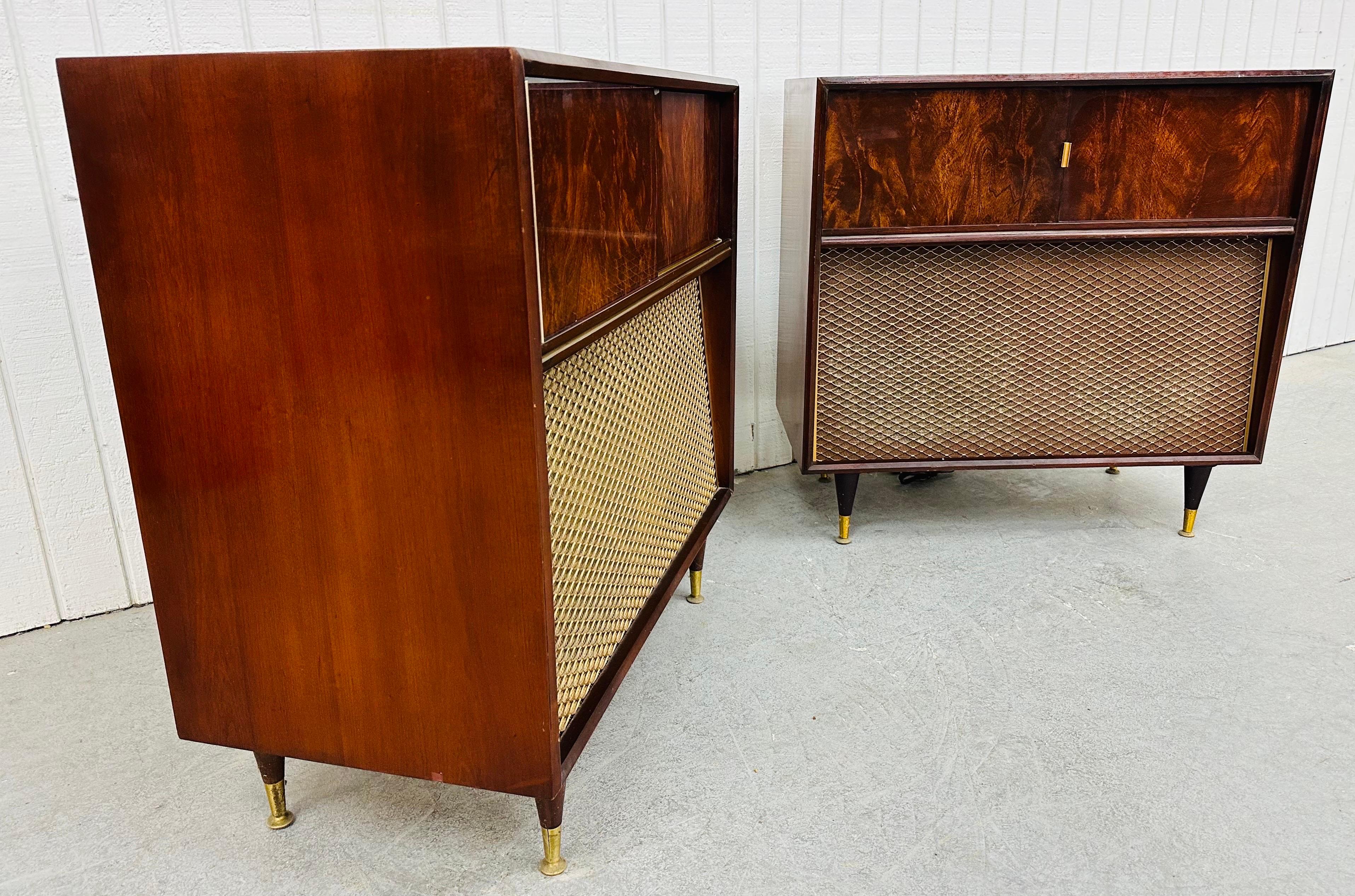 This listing is for a pair of Mid-Century Modern Magnavox Stereo Console Units. Featuring a straight line design, sliding doors that reveal different components, front speakers, modern legs with gold caps, and a mahogany finish. This is an