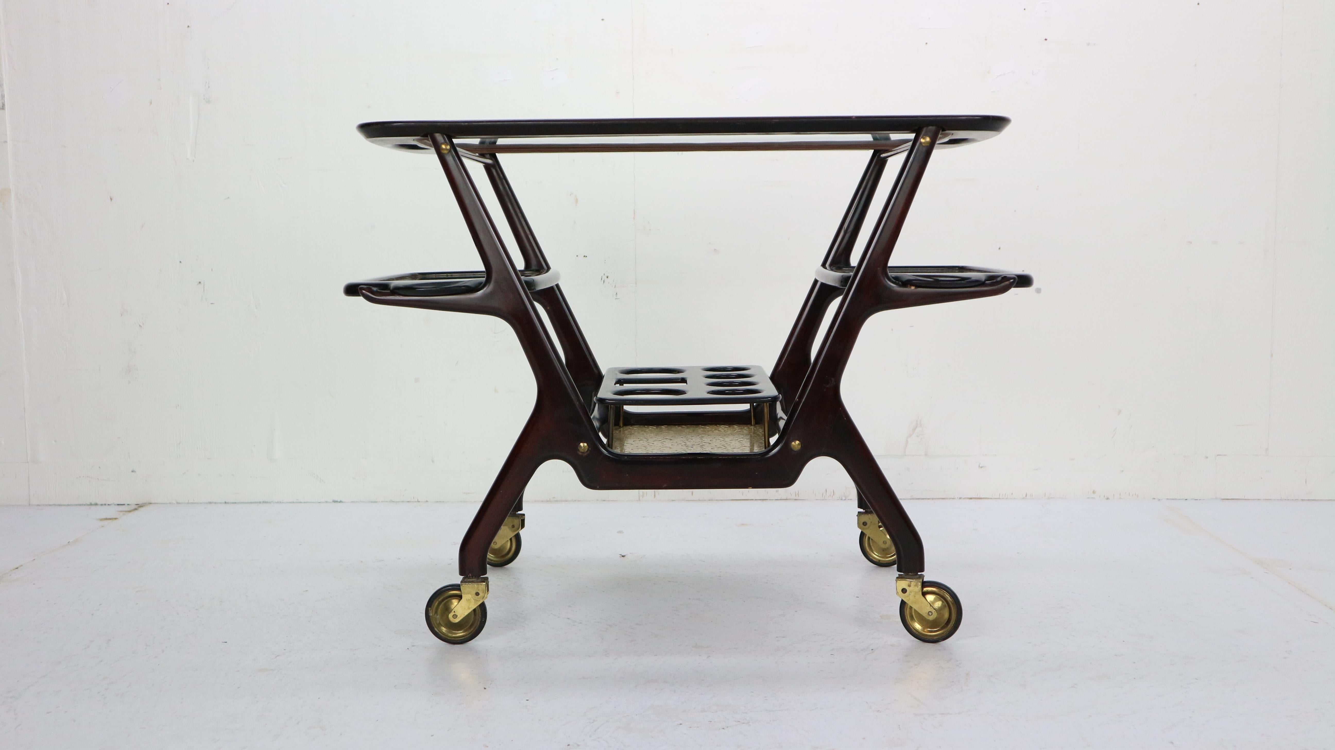 Bar cart or Serving Trolly designed by Cesare Lacca for Cassina, circa 1950s, Italy.
An ebonized mahogany wood bar cart with three removable glass trays, brass fittings and wheels. Elegant Italian Modern peace of furniture for your home or
