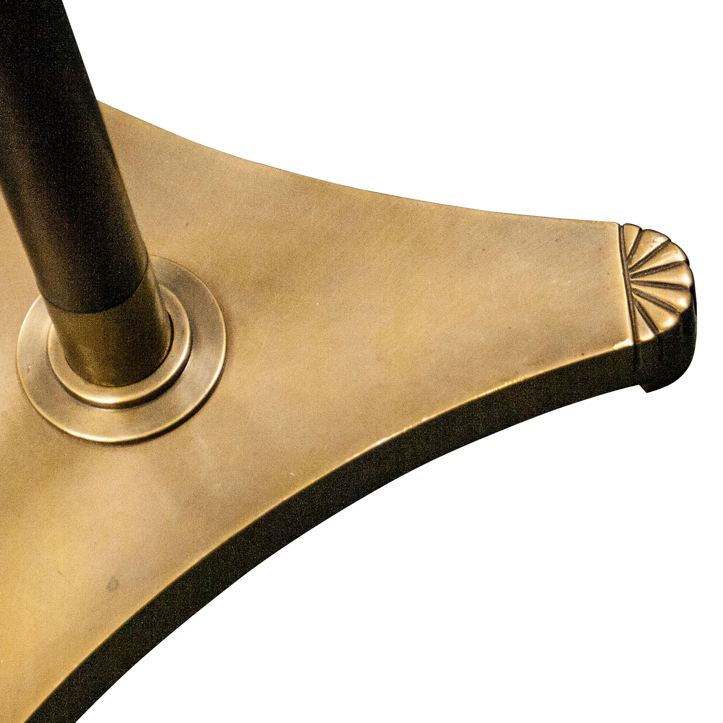 Mahogany floor lamp with brass foot and details. Opaque beige shade and golden inside.