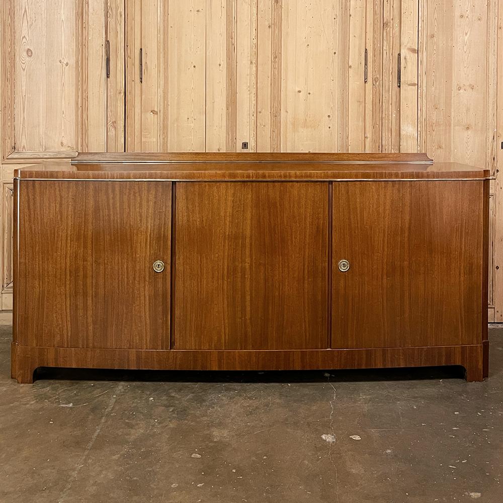 Mid-Century Modern Mahogany Buffet by De Coene is the essence of form following function, with a gracefully bowed front accessed with three cabinet doors, and a subtle backsplash across the back side to keep things on the generous surface. Clean
