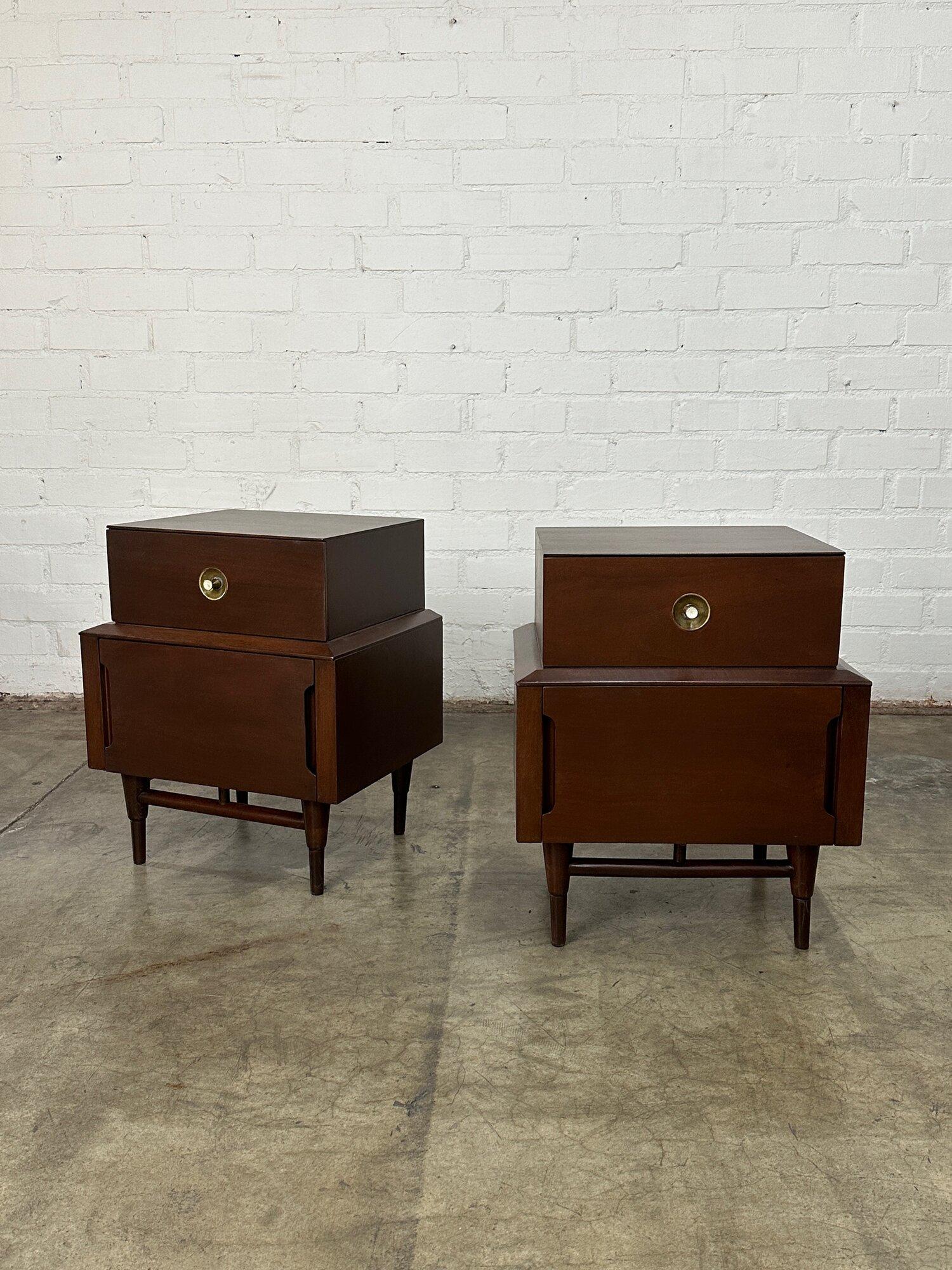 W20 D16 H24.5 Top Width17

Mid Century Modern Mahogany nightstands on a stretcher base, refinished in a walnut stain. Each nightstand has two drawers, the top drawer features one brass knob, and the bottom drawer has recessed pulls on both sides of