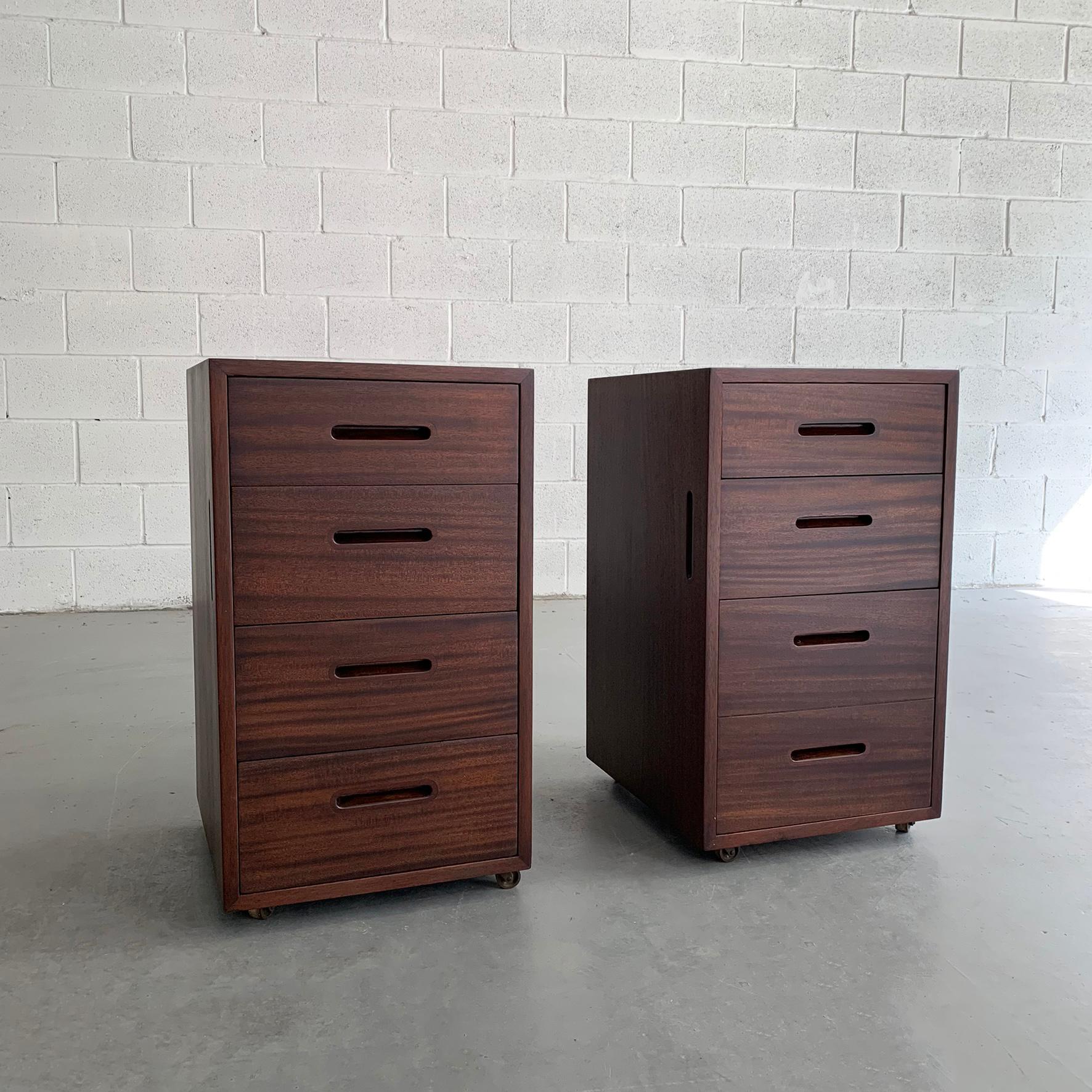 Pair of handsome, Mid-Century Modern, rolling, mahogany, filing cabinets attributed to Edward Wormley for Dunbar feature recessed handles on their 4 drawers and on their sides for mobility. The 3 bottom drawers measure 6.75 inches height and the top