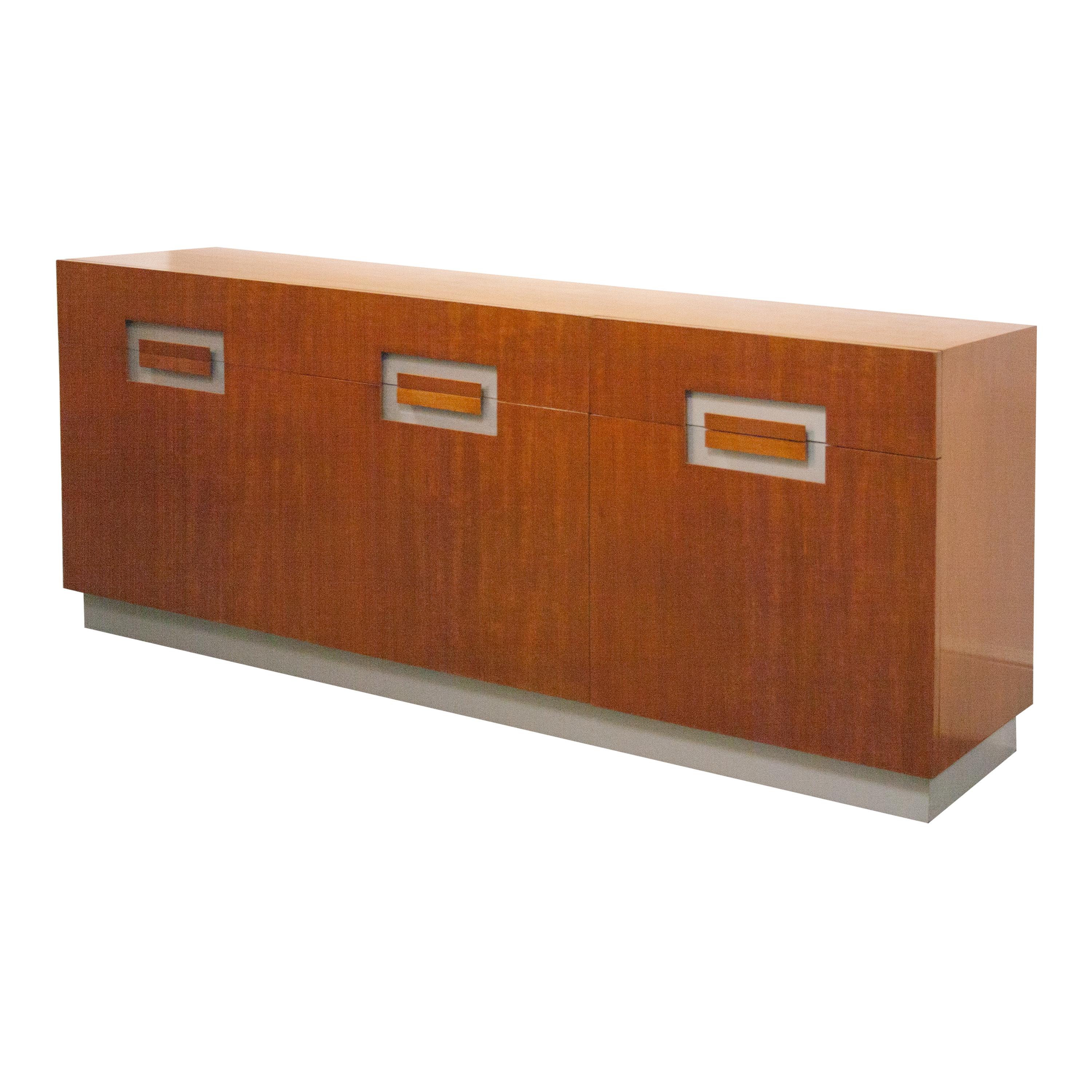 Italian sideboard with three doors, shelving and drawers in the style of Willy Rizzo. Made in Mahogany with handles milled in doors with white details.