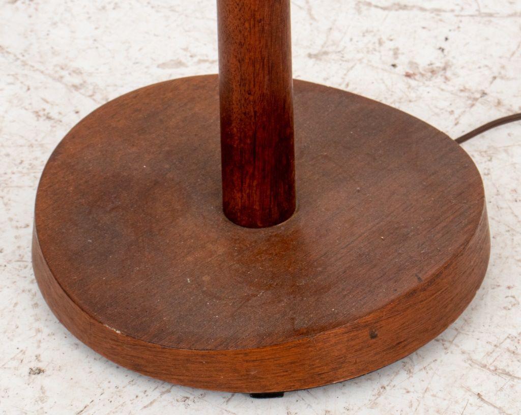 Midcentury modern mahogany torchiere, 1960s,  with flared tapering column on a concave circular base, weighted.