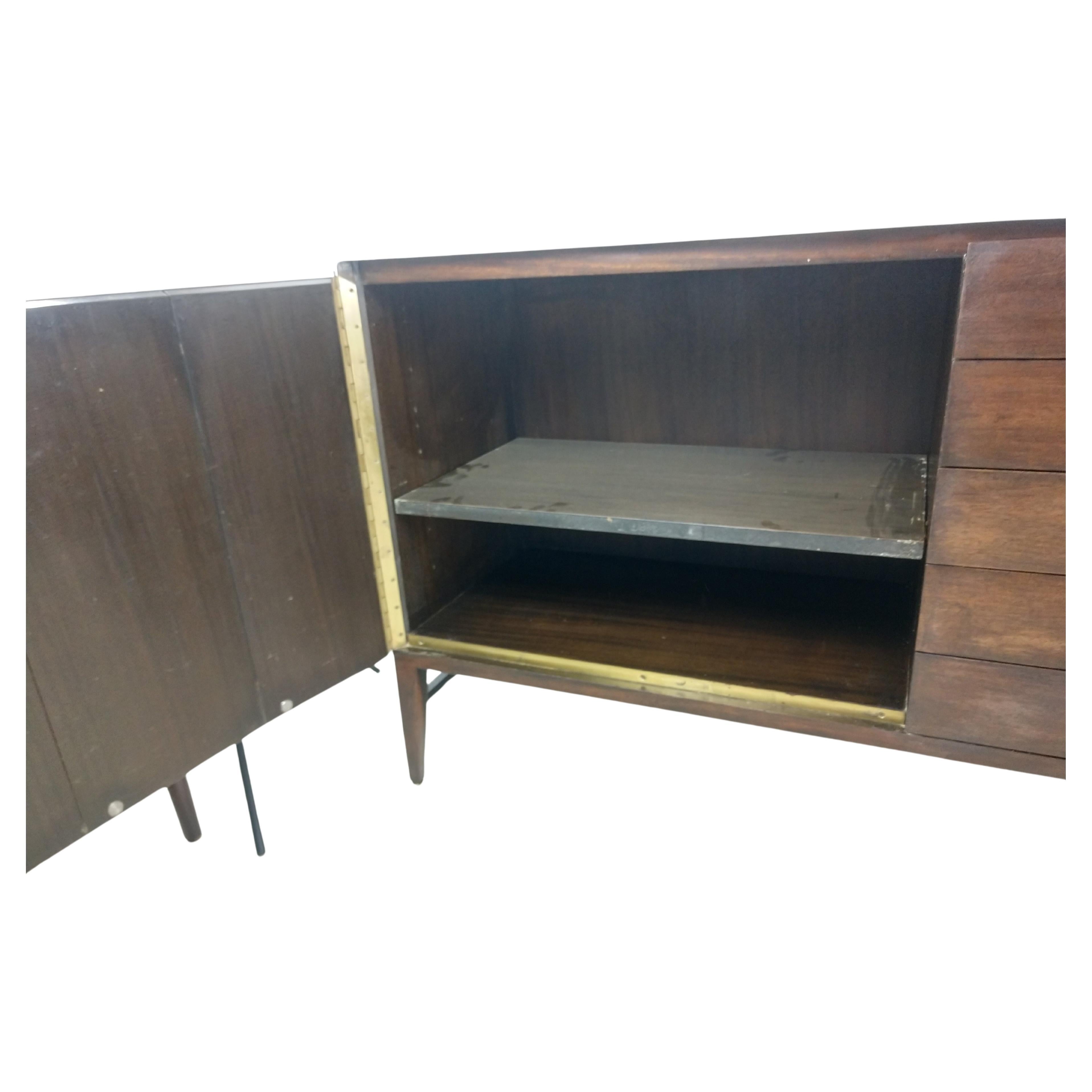 Simple and elegant 5-drawer credenza with large storage compartment which features a shelf. Refinished in the original stain, waxed and polished. White milk glass top is excellent, minor flea bite on the backside edge. Finished back and entire