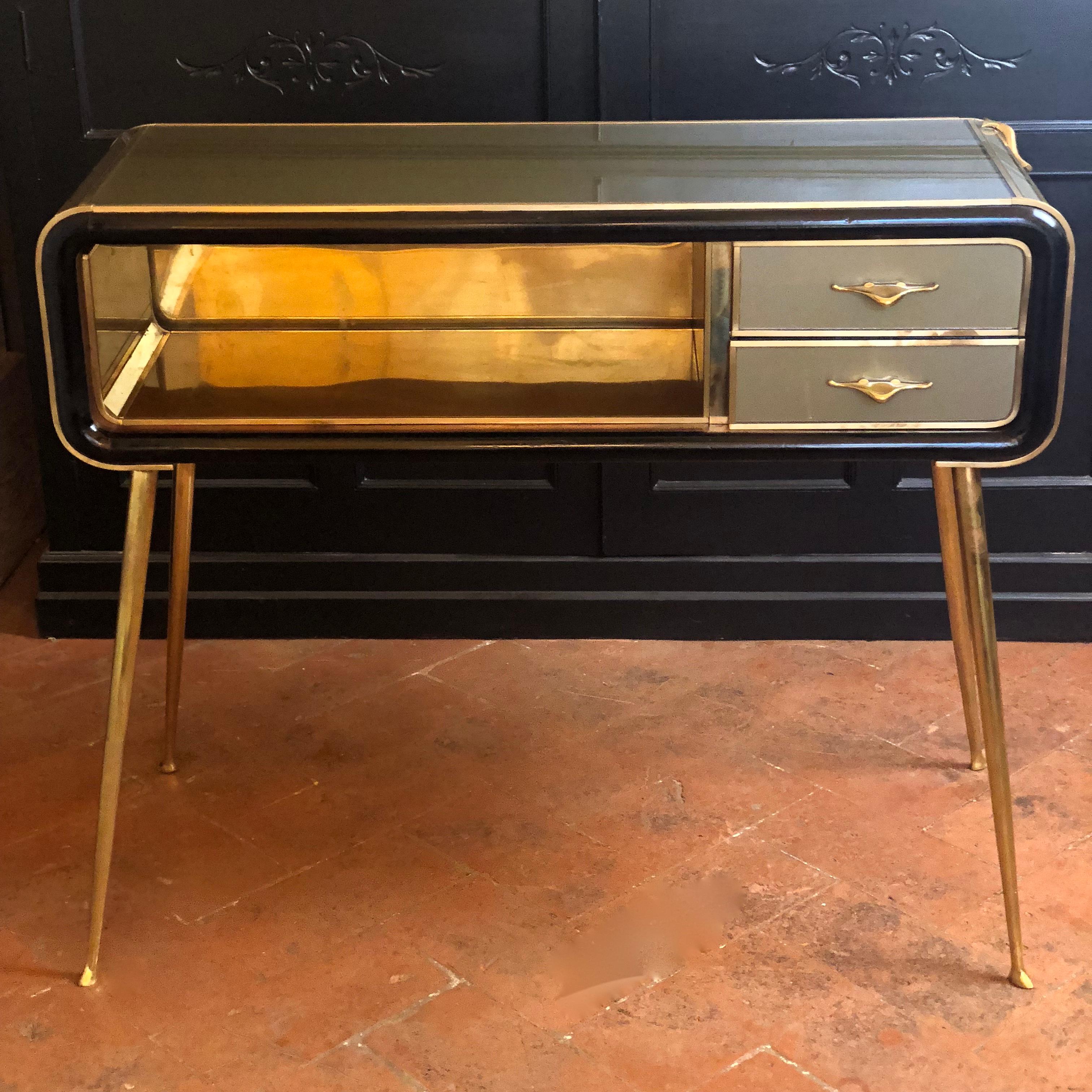 Brass back and powder pink Murano glass inside the shelf (size: 60 x 30 x 19 H cm.). Two small drawers and brass flying bird on the right hand size.