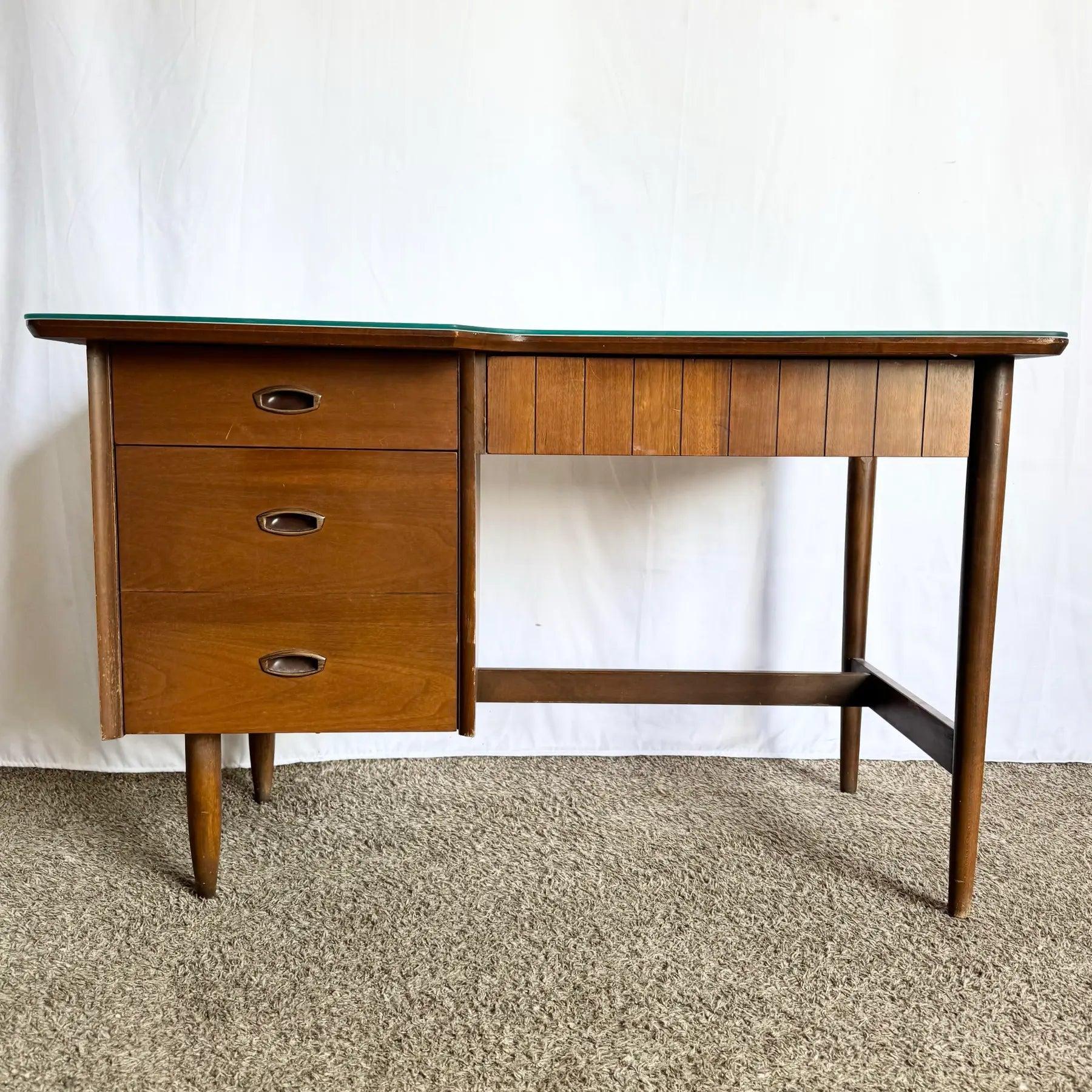 Mid Century Hooker Mainline Desk combines walnut floating top, dovetail drawers, brass pulls, and finished back—iconic 1960s craftsmanship for modern offices.
 

 Some wear on the edges as shown in photos. Some scratches on the glass as shown in the