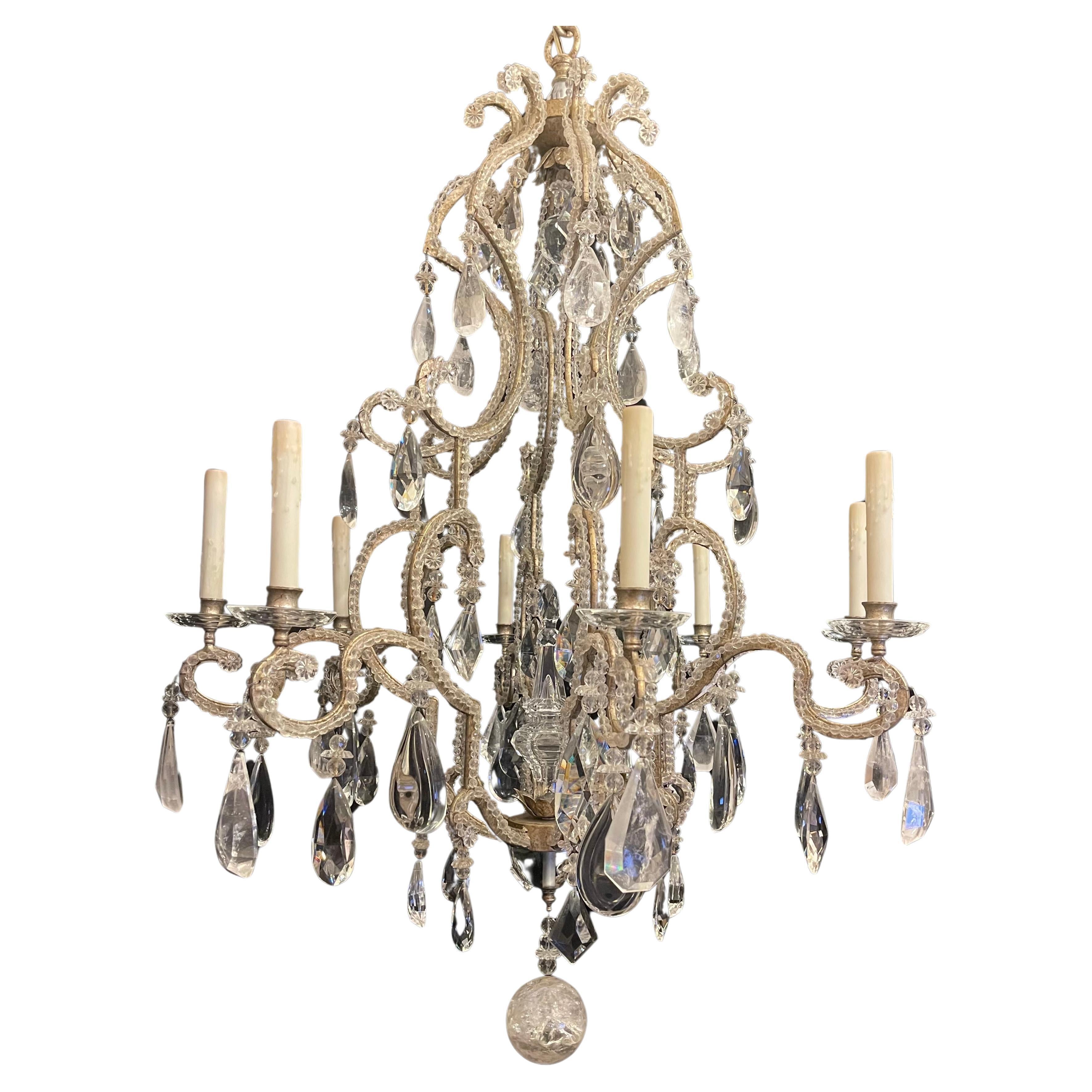 A Wonderful Mid-Century Modern Chandelier In The Manner Of Maison Baguès, Style with silver gilt and beaded french bird cage form body having alternating rock crystal and multi dimensional crystals through out, this large chandelier has 8 candelabra