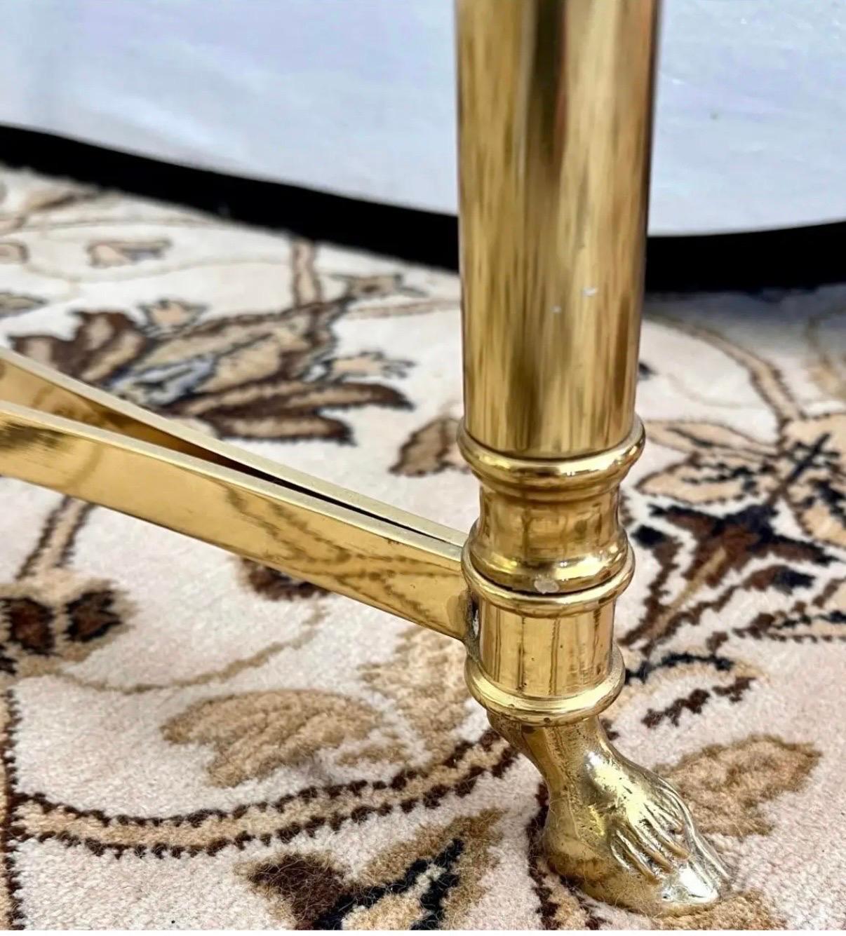Mid century oval brass coffee table with beveled glass top and stretcher over small hoof feet.  Iconic in every way, attributed to Maison Jansen.