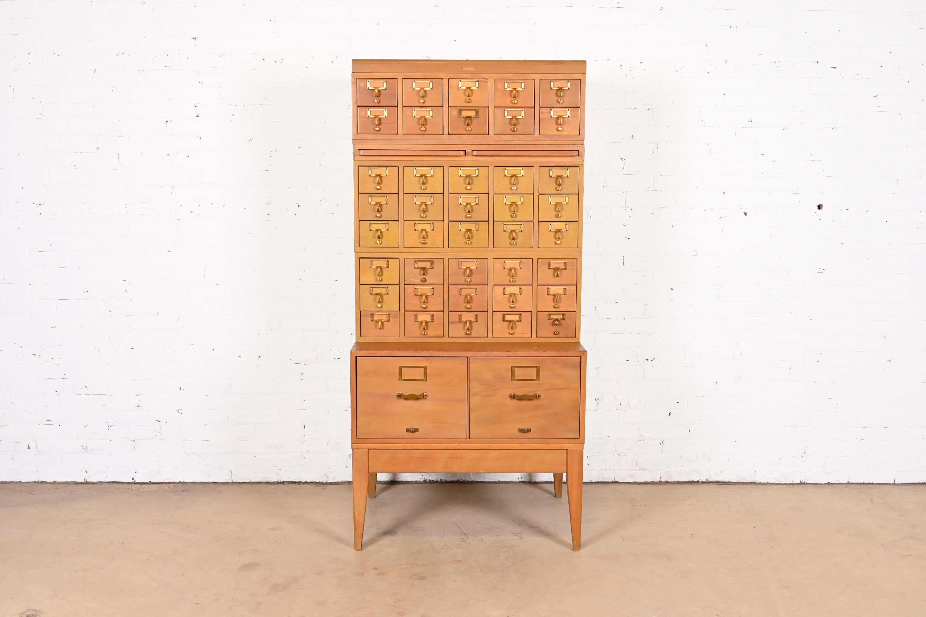 A beautiful Mid-Century Modern 42-drawer library card catalog or file cabinet with two pull-out writing tablets

By Remington Rand

USA, Circa 1950s

Maple, with brass hardware.

Measures: 33