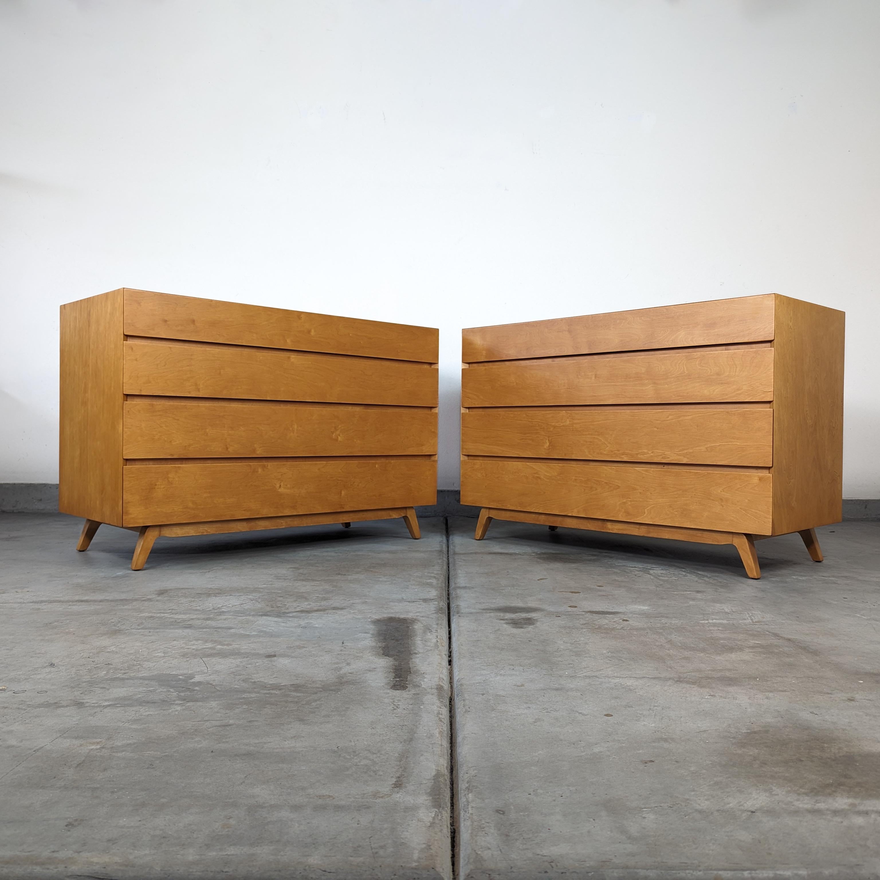 Embrace the timeless elegance and functional beauty of Mid-Century Modern design with this exquisite pair of maple chest of drawers, crafted by the renowned designer Edmond Spence in the 1950s. Each dresser, measuring an ample 46 inches in width, 20