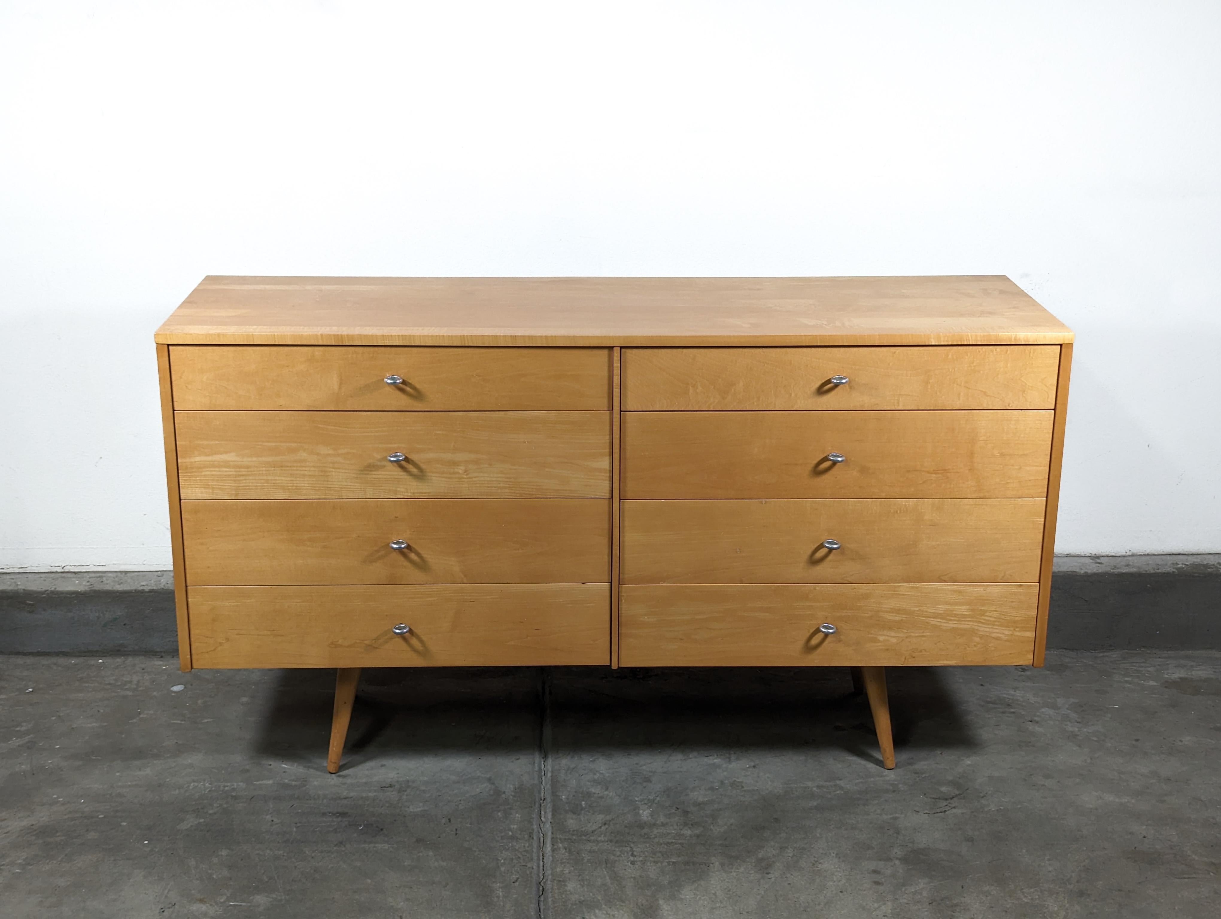 For sale is a stunning mid-century modern dresser designed by the renowned Paul McCobb for his Planner Group collection. Dating back to the 1950s, this piece is not just furniture - it's a slice of design history.

Crafted from solid maple, the