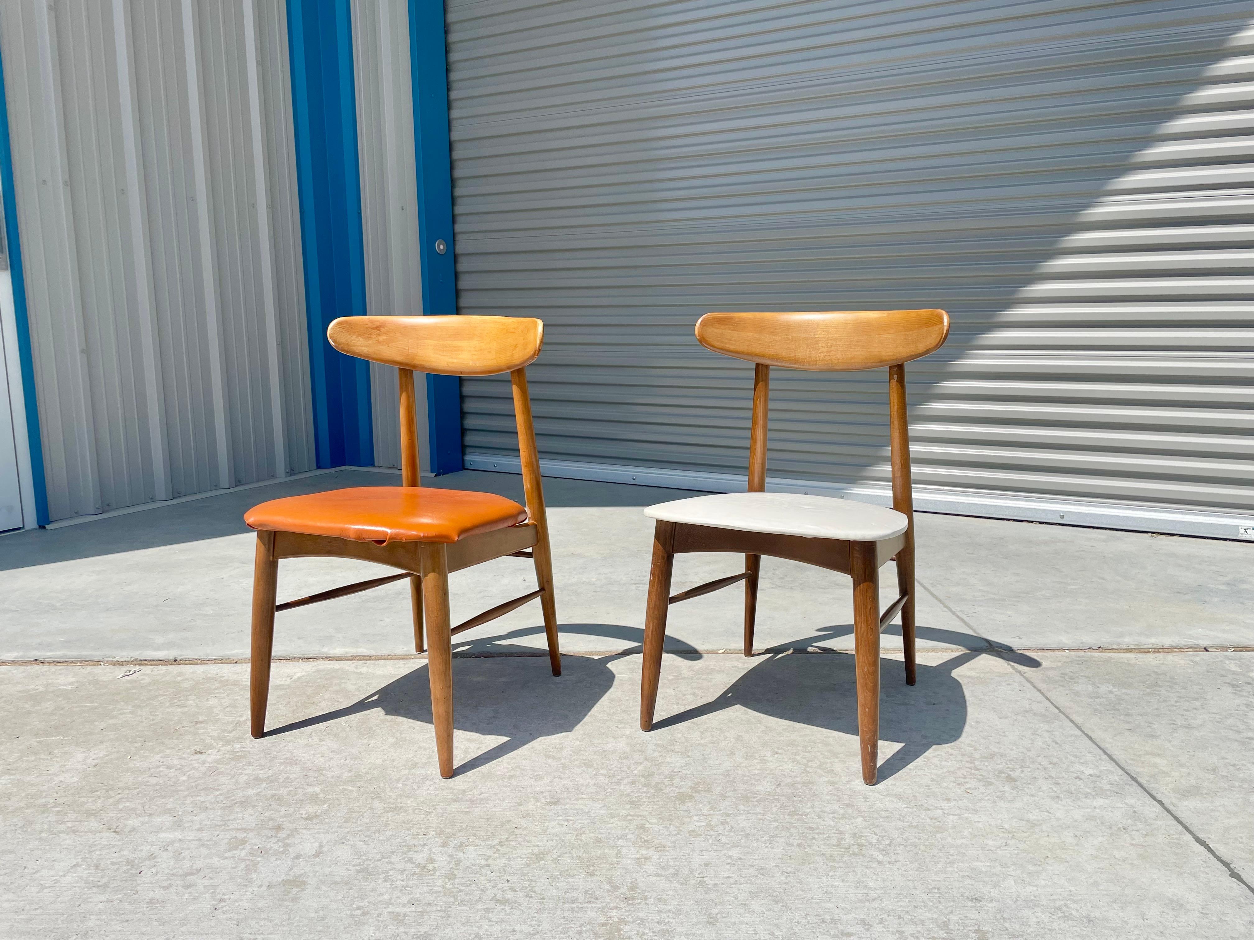 Pair of mid-century modern maple side chairs designed and manufactured in the United States during the 1960s. These chairs are truly a sight to behold, with a beautiful maple wooden frame that is both elegant and sturdy. One of the most striking