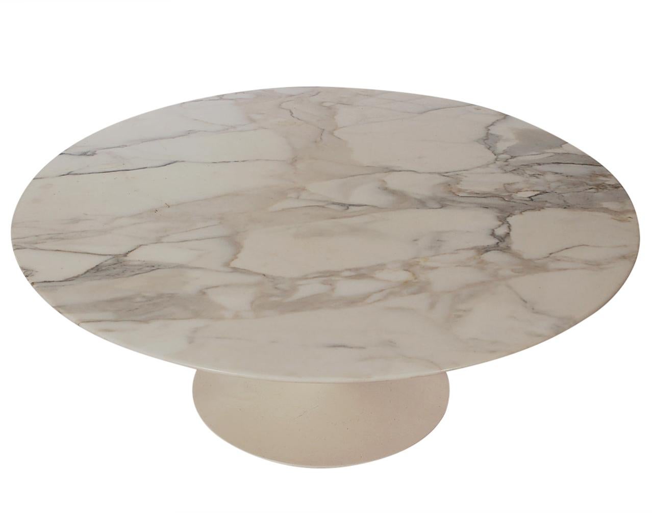 An early example of Eero Saarinen's Tulip table produced by Knoll in the early 1960s. This table features a cast iron weighted aluminum base with circular marble top. All original in great condition.