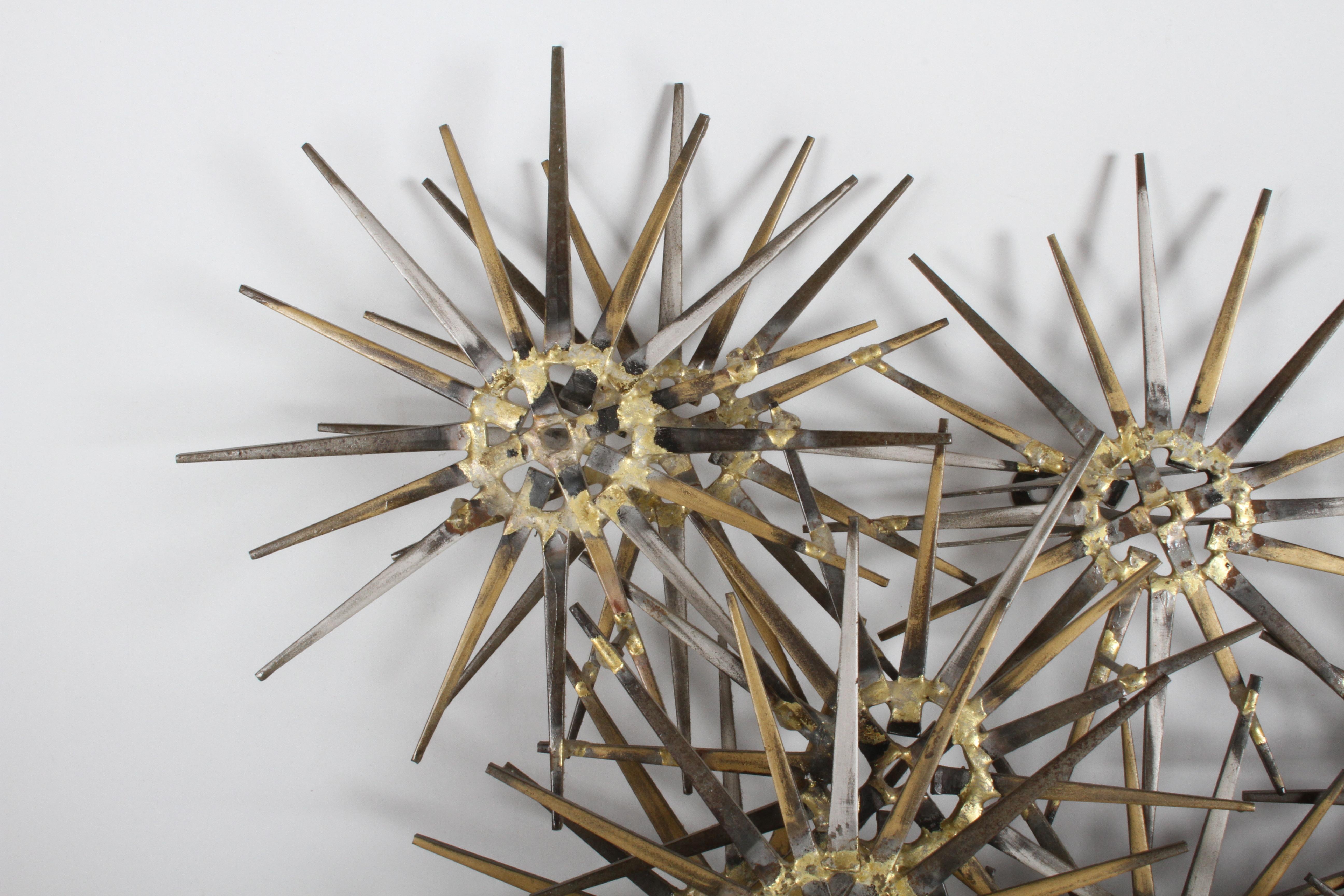 Wall sculpture by Marc Weinstein, cluster of stars with gold, silver and black paint. Signed Marc Creates, St. Louis Mo, in the manner of Curtis Jere, circa 1960s.

 