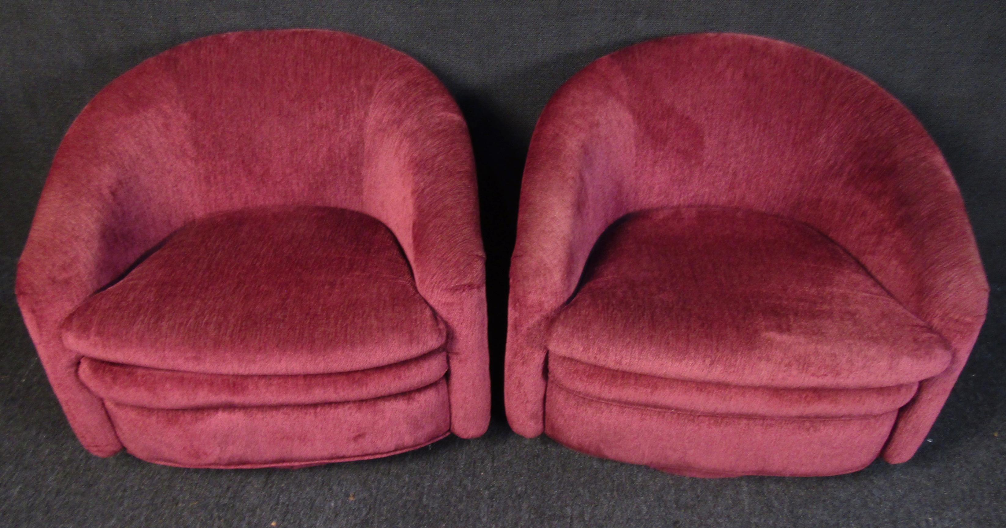 Unique vintage modern lounge chairs. These plushy lounge chairs are upholstered in a vibrant maroon fabric in amazing condition. Swivel bases give added functionality, perfect chairs for entertaining!

Please confirm item location (NY or NJ).