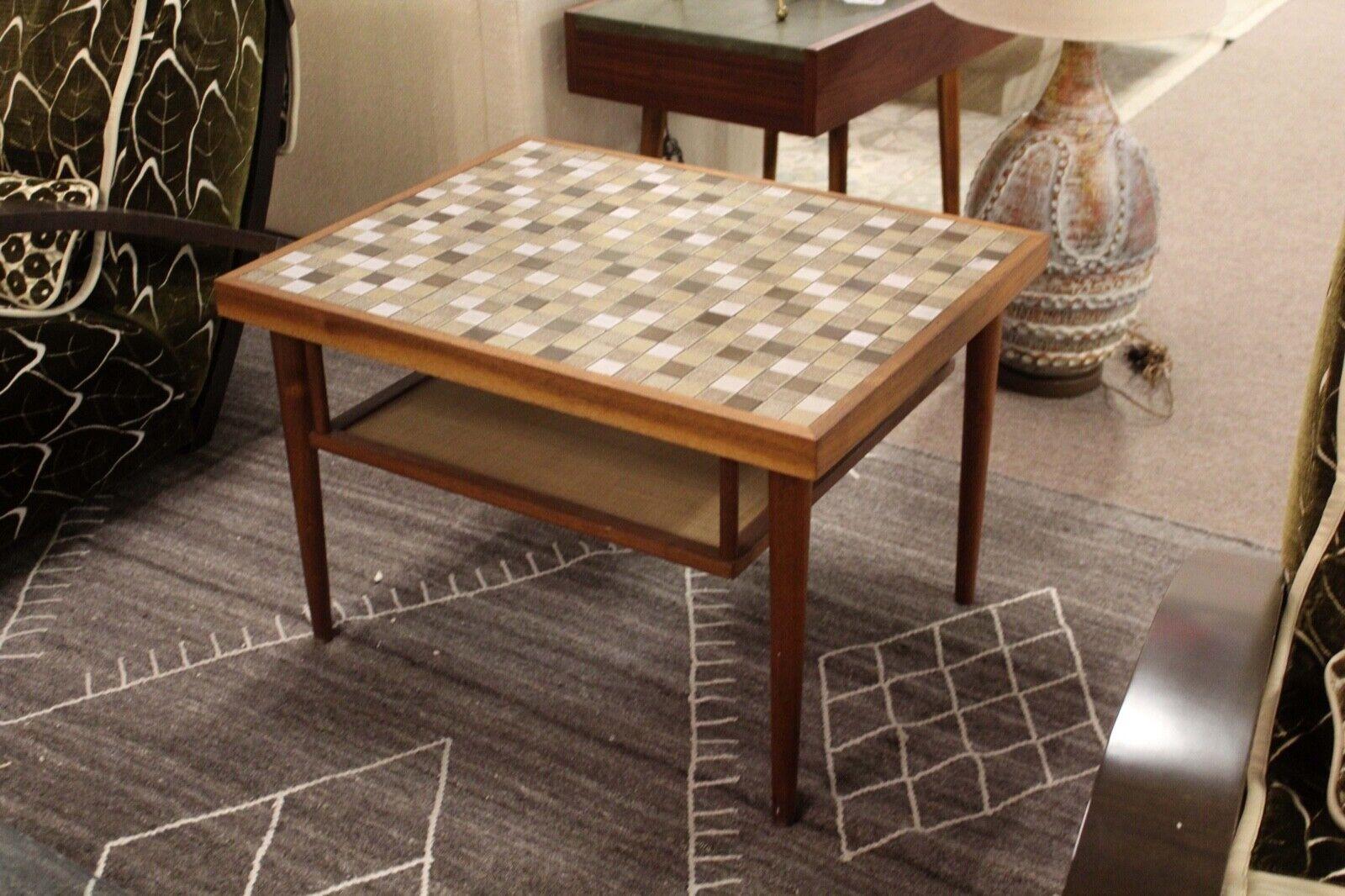 A lovely Gordon and Jane Martz side/end table up for consideration. Walnut wood base topped with inlaid earthy green colored tiles allows for a perfect color balance. This stylish piece would be a great fit for anyone with a Mid-Century Modern house