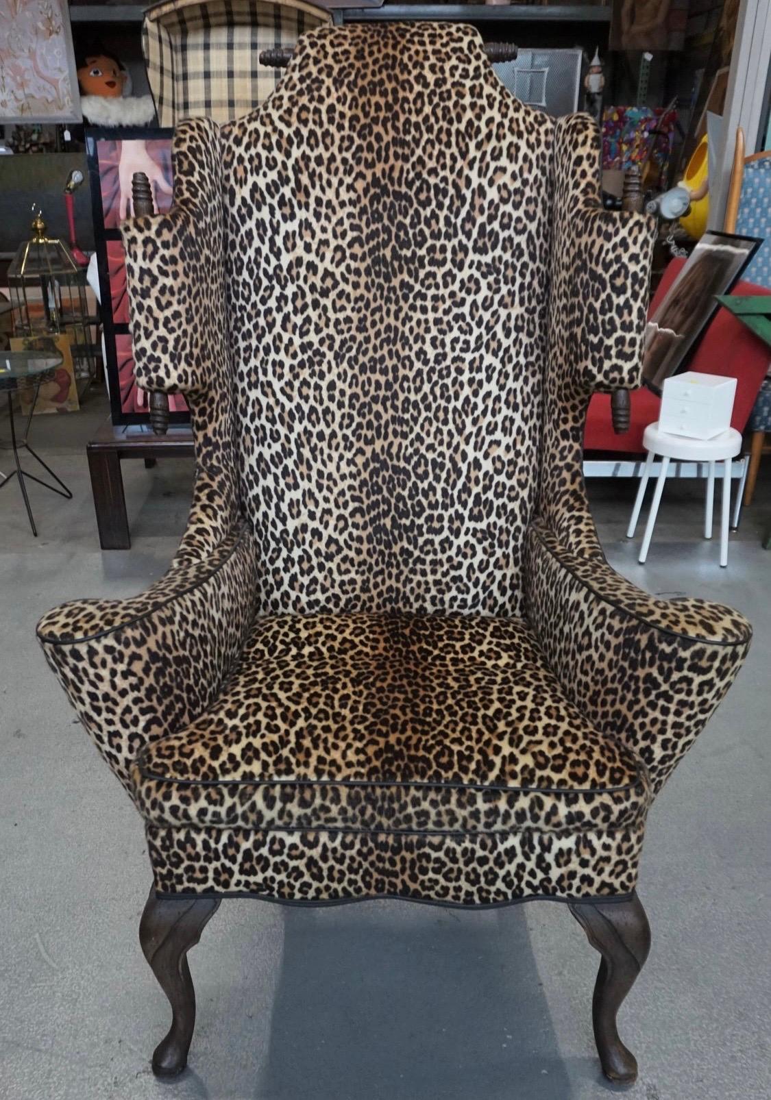 A very large chair with great scale and presence. Made in the 1970's by Mason Art, New York. This was certainly a custom piece. Reupholstered by our client in a faux leopard fur on front and leatherette on back. The wood is dark stained walnut. It