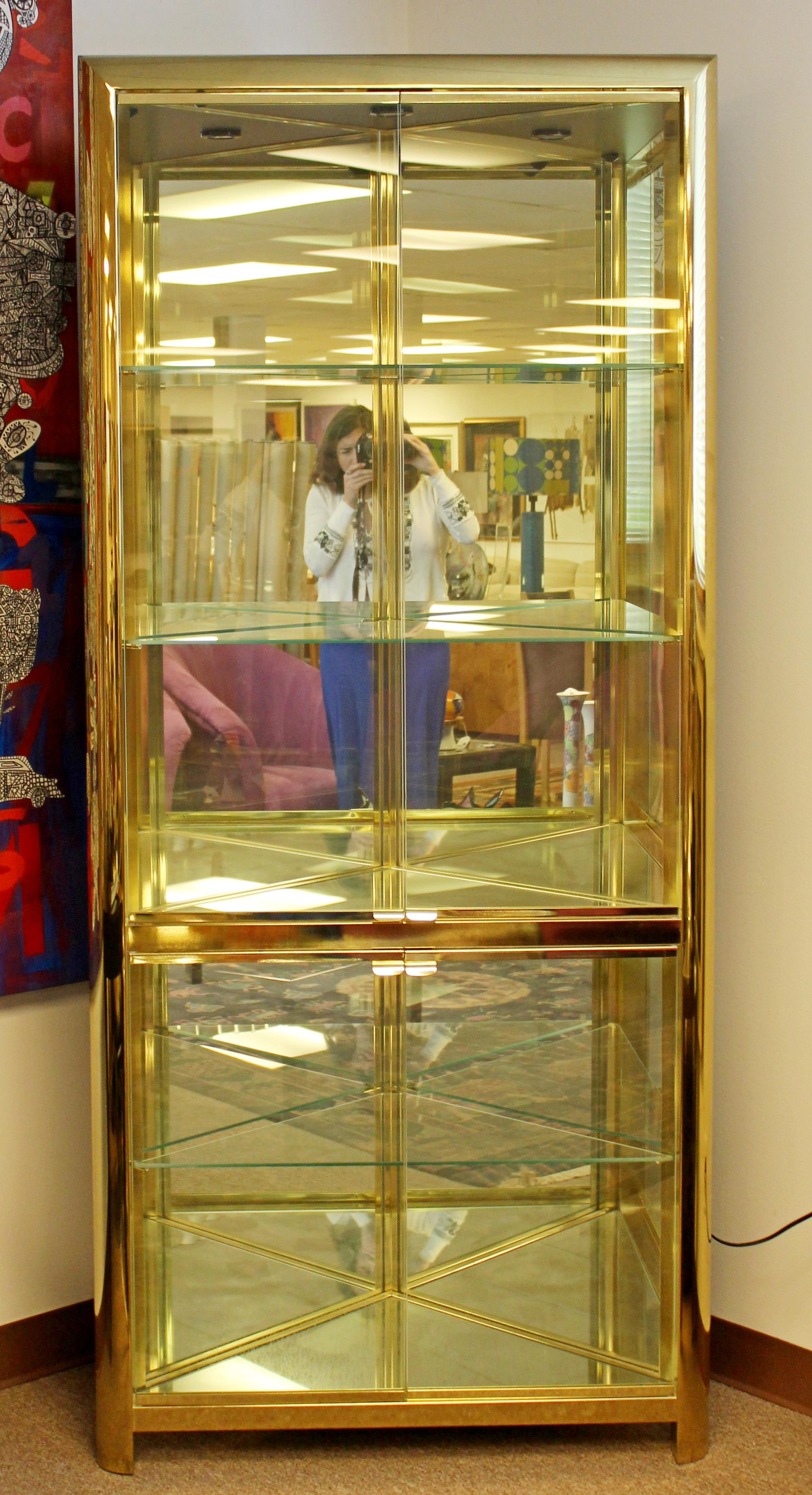 For your consideration is a lux looking, light up, brass and glass shelving unit corner cabinet, with five shelves, by Mastercraft, circa 1970s. In excellent vintage condition. The dimensions are 35