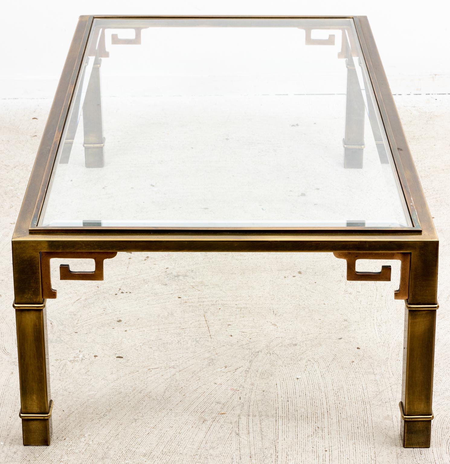 Circa 1970s Mid-Century Modern style Mastercraft brass Greek key coffee table with rectangular glass top. Made in the United States. Please note of wear consistent with age including very minor patina in some areas and minor chipped glass in the