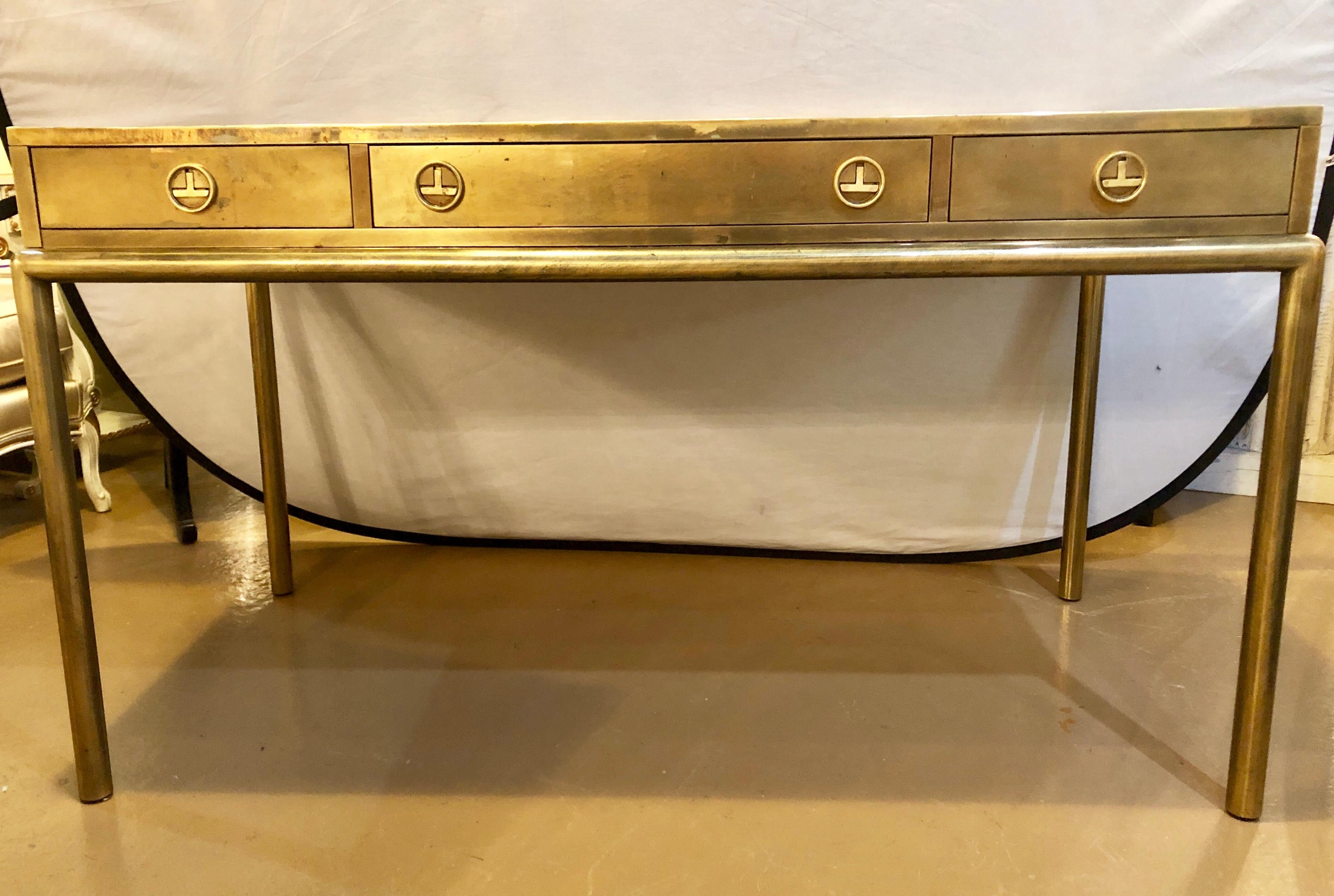 Bernhard Rohne Mid-Century Modern Mastercraft bronze desk in an oriental motif. This fine three drawer desks is made of solid patinated bronze over wood construction by this highly sought after designer. The whole showing worn leather top with gilt