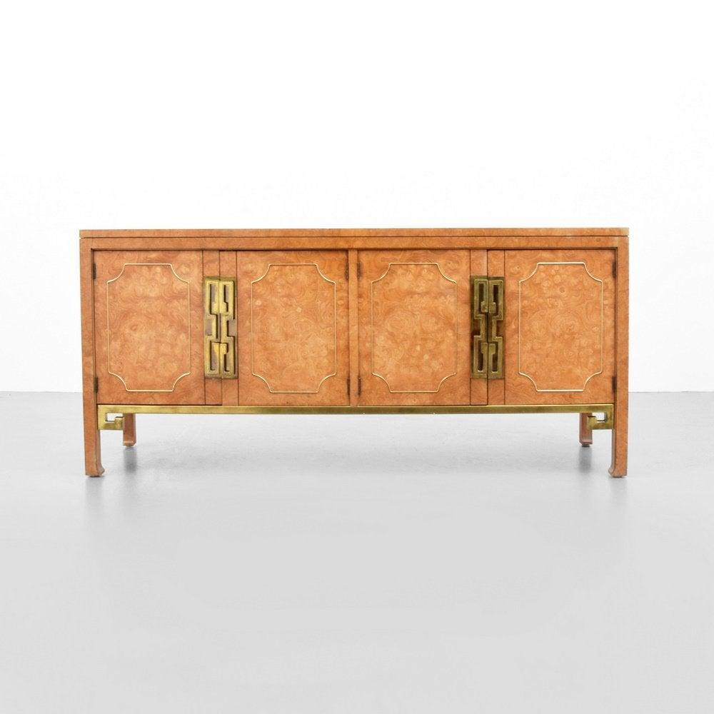Iconic Mastercraft credenza in burl wood professionally refinished. This piece exudes midcentury at it's finest. The massive Greek Key pulls and stretcher details are incredible. And offers plenty of storage with two interior wide drawers and