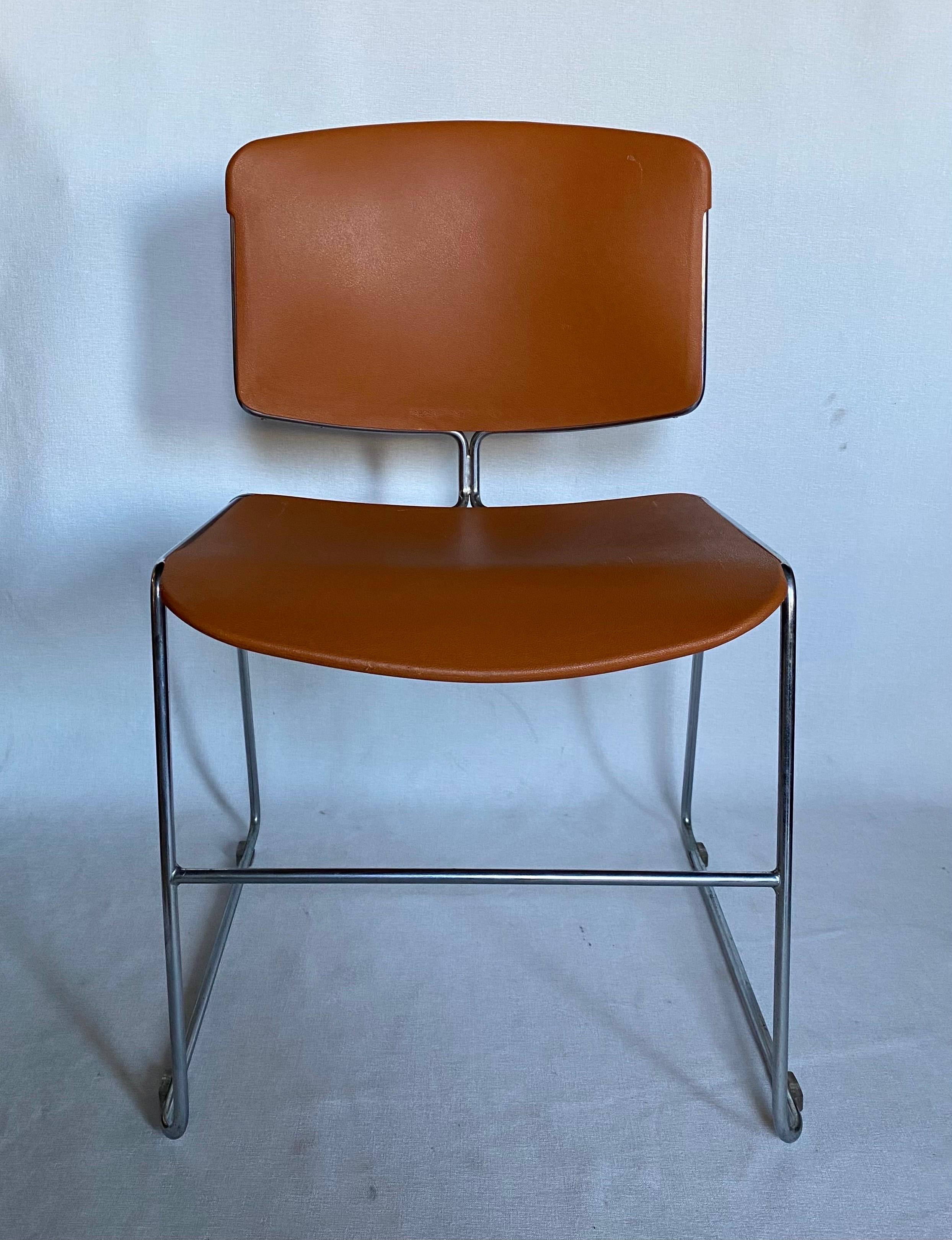 Mid-Century Modern Max Max-Stacker office conference room chairs by Steelcase in iconic orange. These comfortable lounge or desk chairs feature molded curved seats and backs with polished chrome tubular frames. From the conference room to the dining