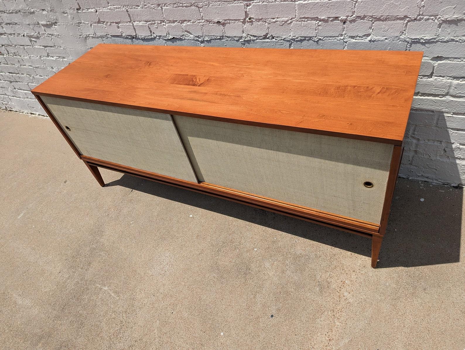 Mid Century Modern McCobb Planner Group Credenza

Average vintage condition and structurally sound. Has some dings on edges. Front has some very light soiling around pulls. Credenza has been refinished and does not have the original coloring or