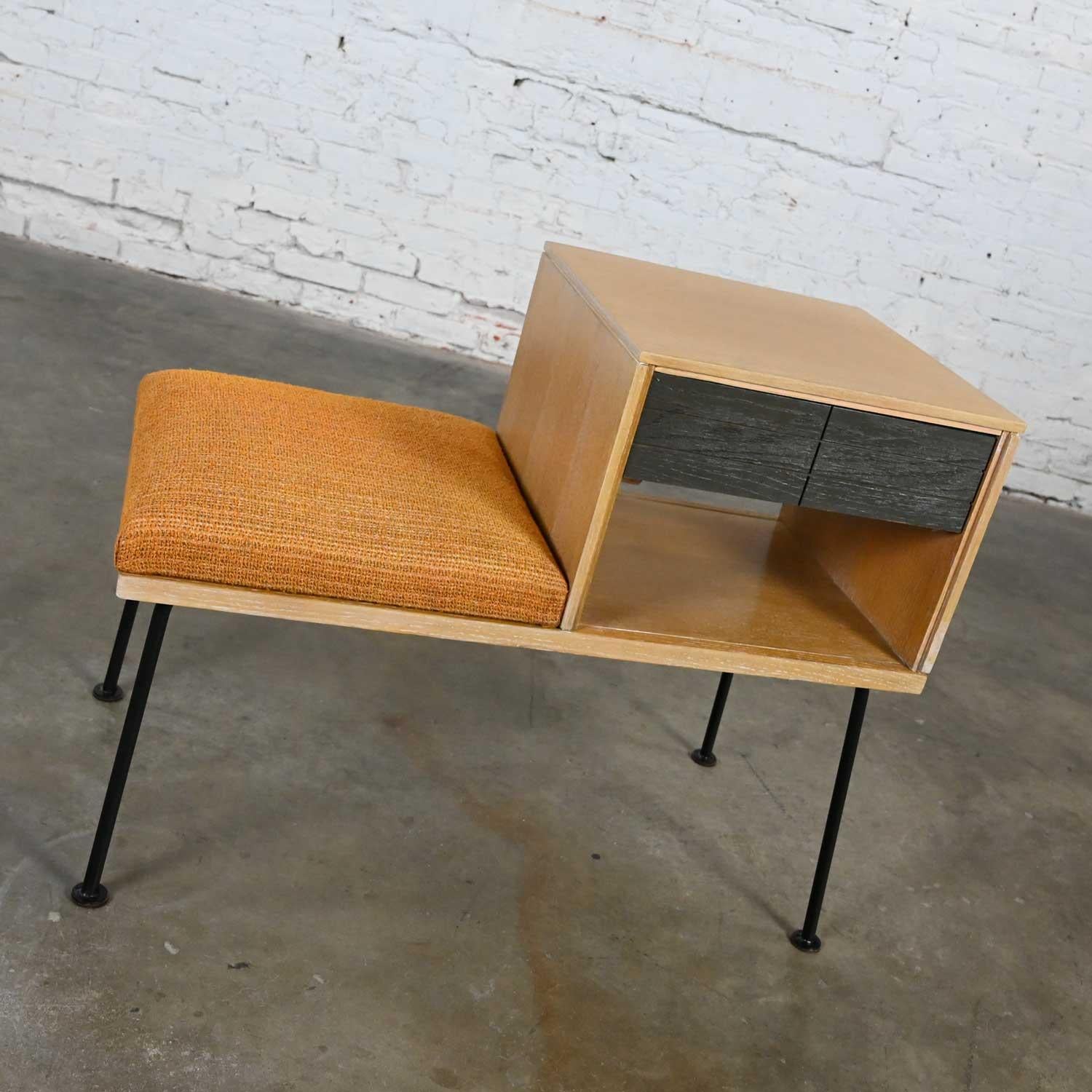Wonderful vintage Mid-Century Modern Mengel telephone bench by Raymond Loewy. Comprised of a limed oak case, cerused oak drawer fronts, black iron legs and the original gold upholstery. Beautiful condition, keeping in mind that this is vintage and
