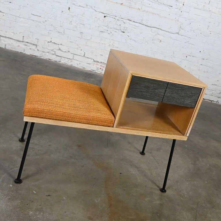 Wonderful vintage Mid-Century Modern Mengel telephone bench by Raymond Loewy. Comprised of a limed oak case, cerused oak drawer fronts, black iron legs and the original gold upholstery. Beautiful condition, keeping in mind that this is vintage and