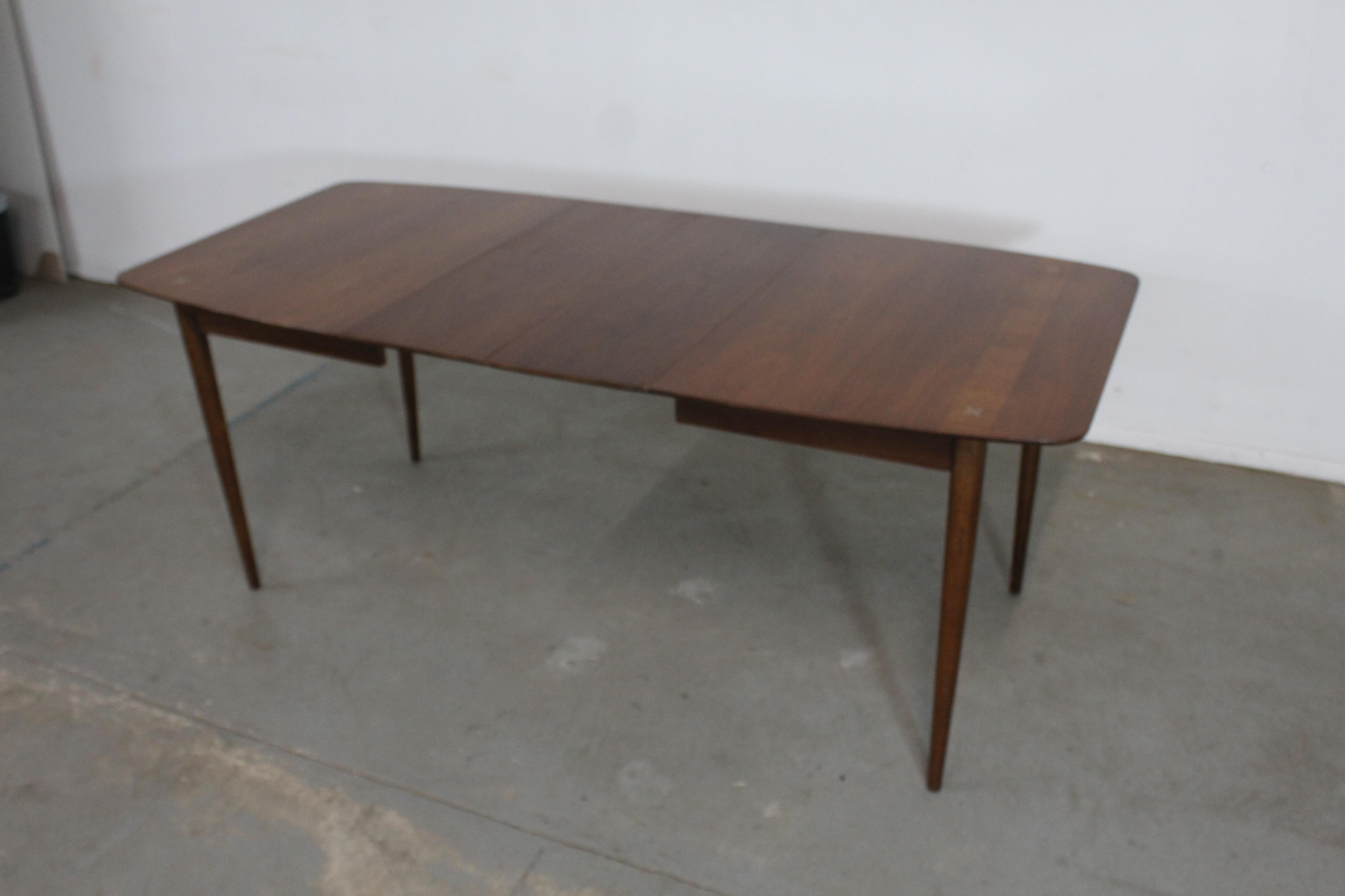 Mid-Century Modern Merton Gershun walnut dining table W 2 extensions
Offered is a Mid-Century Modern Merton Gershun walnut dining table W 2 extensions. The table is by American of Martinsville. This table is prefect for city living or interior
