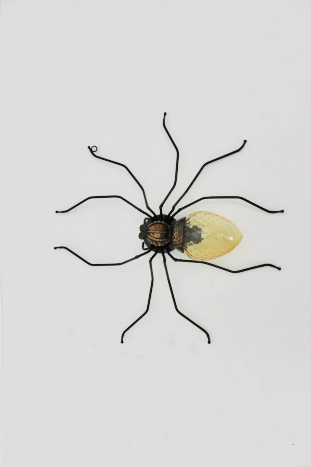 Large sized mid century modern handmade wall lamp shaped like a spider. The legs were made of metal wire, while the glass shade was made of yellow grooved glass with a E 14 socket.

The condition is very good - carefully cleaned.
Measures:
Width 60