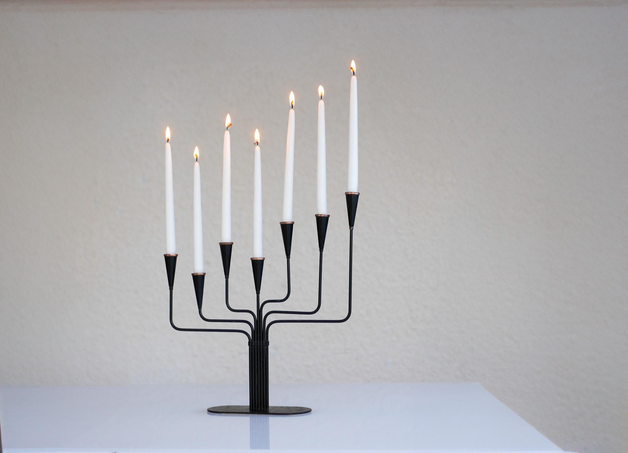 A very nice vintage candlestick holder designed by Gunnar Ander in the 1960s and produced by Ystad Metal in Sweden. The shape is very simple yet still very elegant and sophisticated with the irregular seven arms. It is made from black painted metal