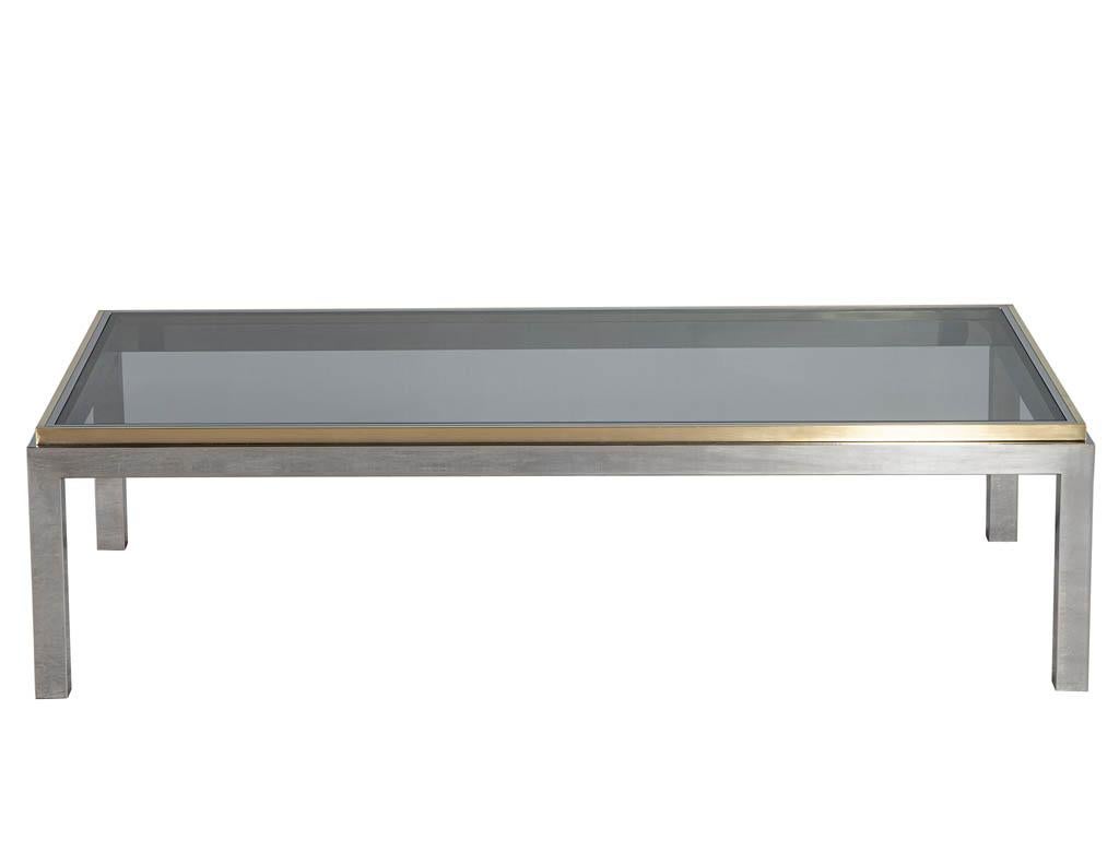 Mid-Century Modern metal cocktail table Maison Jansen. All original, France, circa 1970’s. Features brass plated center portion supporting the black smoked glass top. Completed with stainless steel frame. Metal frame and glass have minor wear