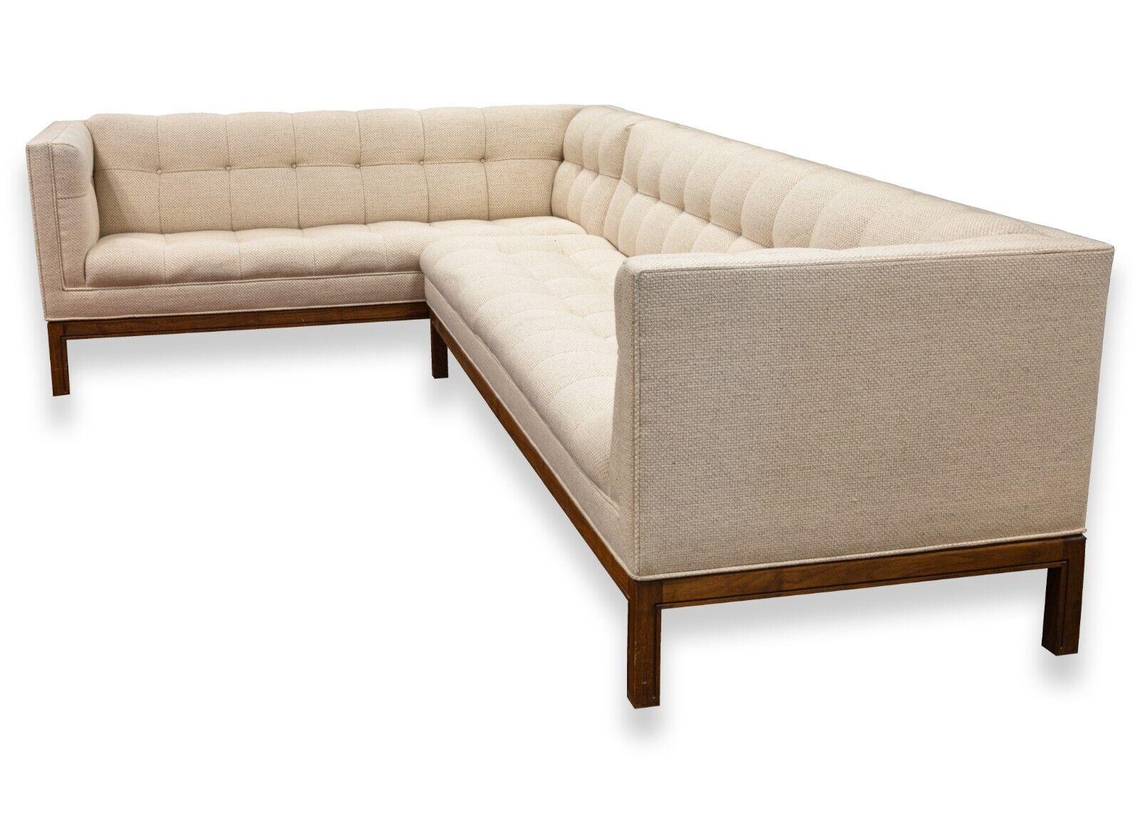 A Metropolitan cream sofa sectional. A lovely sofa sectional from San Francisco based furniture brand Metropolitan. This sofa sectional features a two piece L-design. The upholstery features a beautiful tufted cushion design on both the seat and the