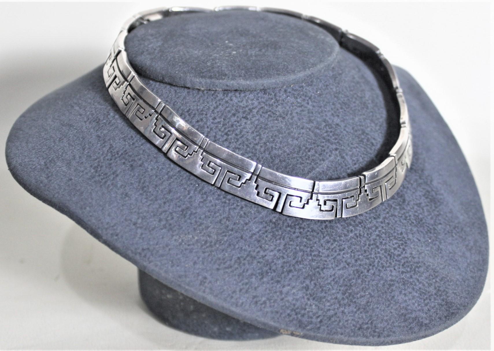 This chunky sterling silver ladies choker necklace was made in Mexico in approximately 1970 in a Mid-Century Modern style. The thick sterling silver links are geometrically shaped in a stylized Aztec manner, and have some simple accenting