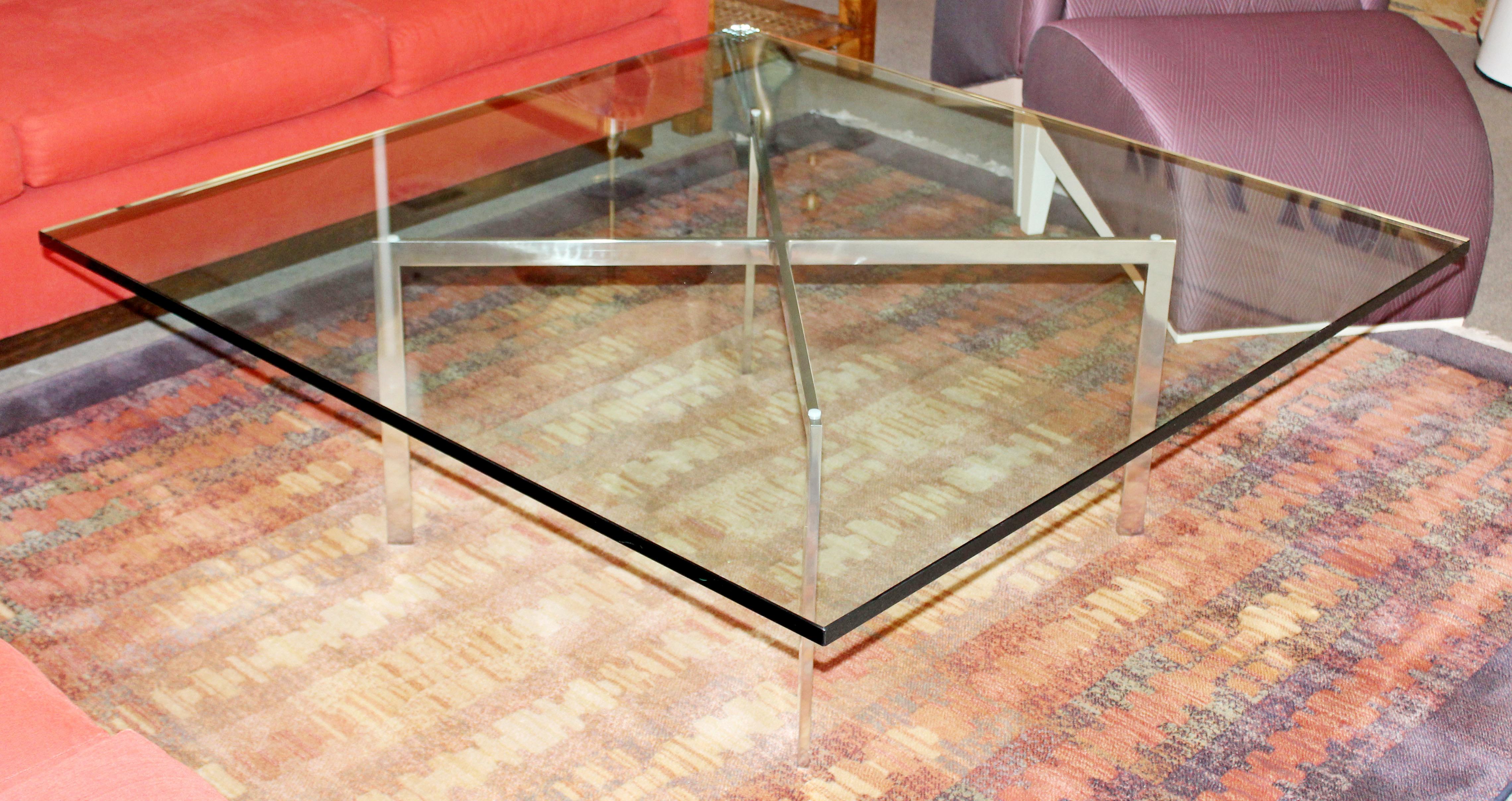 For your consideration is an original Barcelona coffee table, with a square glass top on a stainless steel base, by Ludwig Mies van der Rohe for Knoll, circa 1970s. In very good condition, with some minor surface scratches on the glass. The