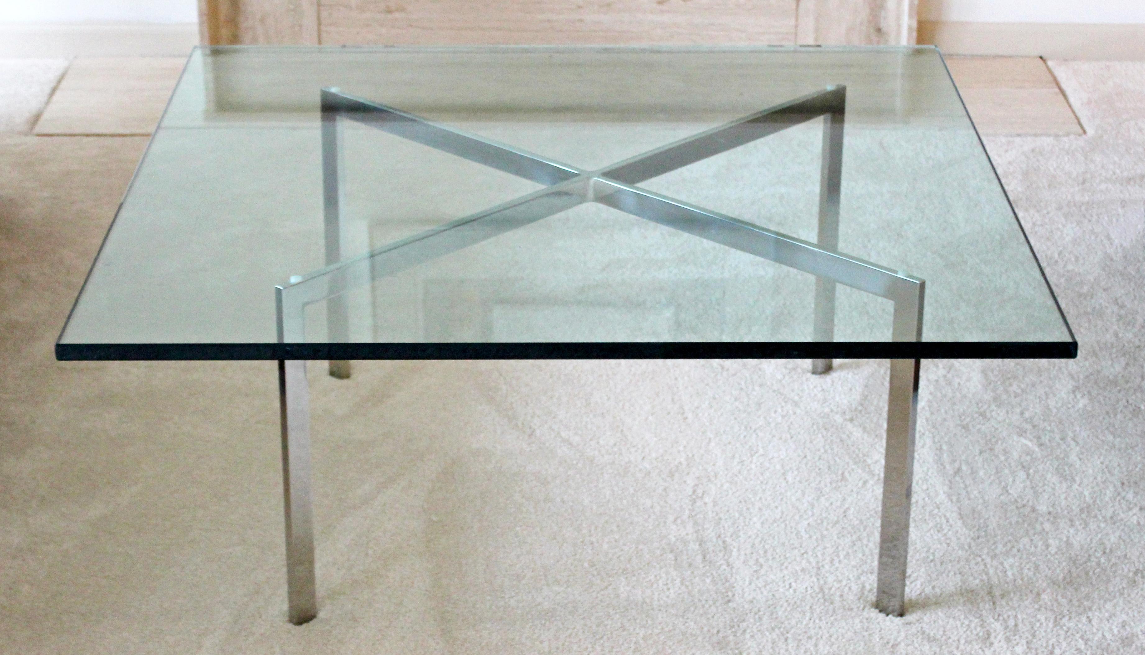 For your consideration is an original Barcelona coffee table, with a square glass top on a stainless steel base, by Ludwig Mies van der Rohe for Knoll, circa the 1970s. In excellent condition. The dimensions are 48