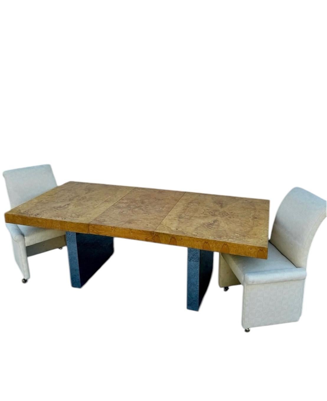 Beautiful burl wood dining table, on chrome legs, designed by Milo Baughman, circa the 1970s. Includes two leaves. In very good condition. The dimensions are: With both leafs 110