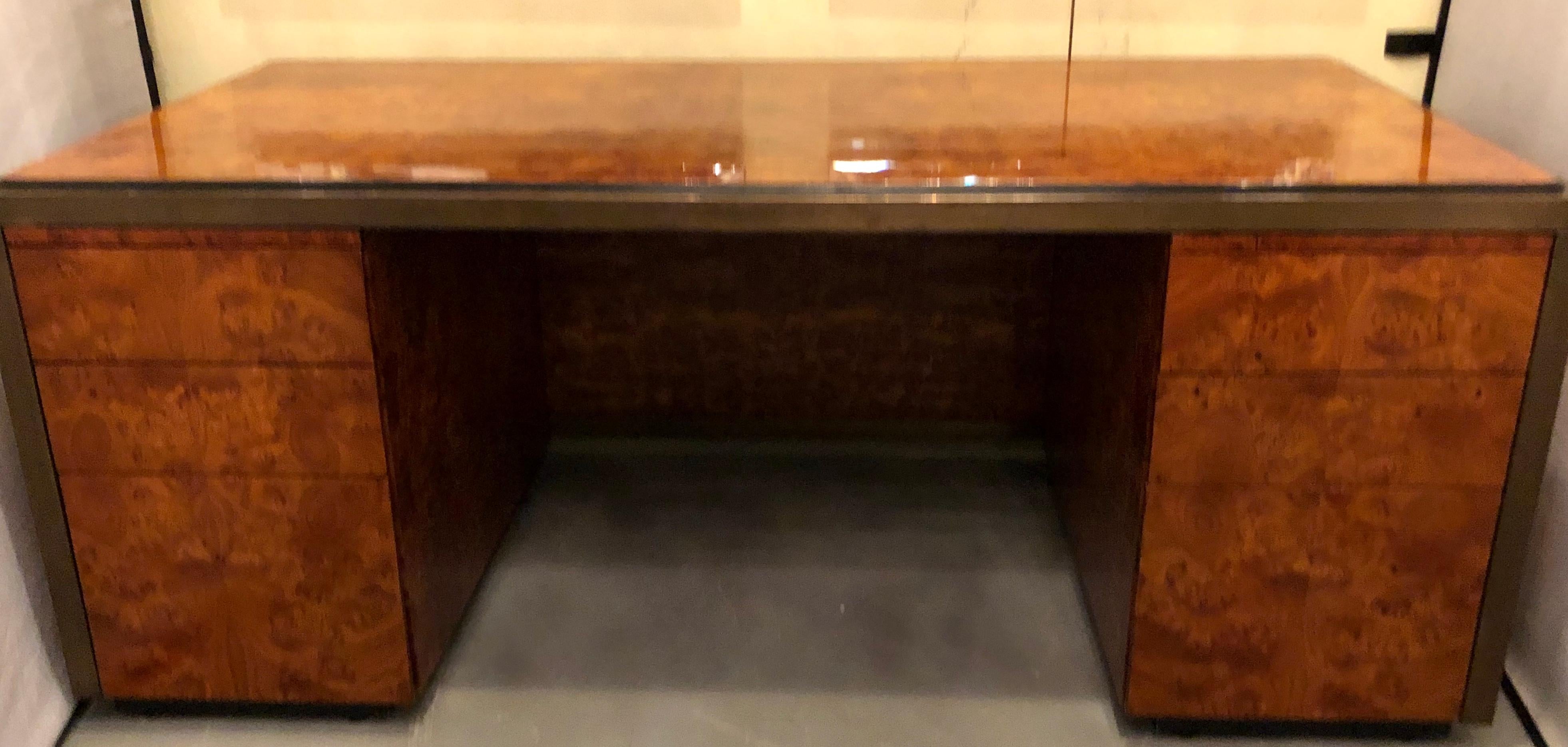 Mid-Century Modern burl wood palatial writing desk. This fine large and impressive burl and bronze mounted office or writing desk is simply stunning and has been fully refinished. The two large file cabinet drawers under a pair of side by side