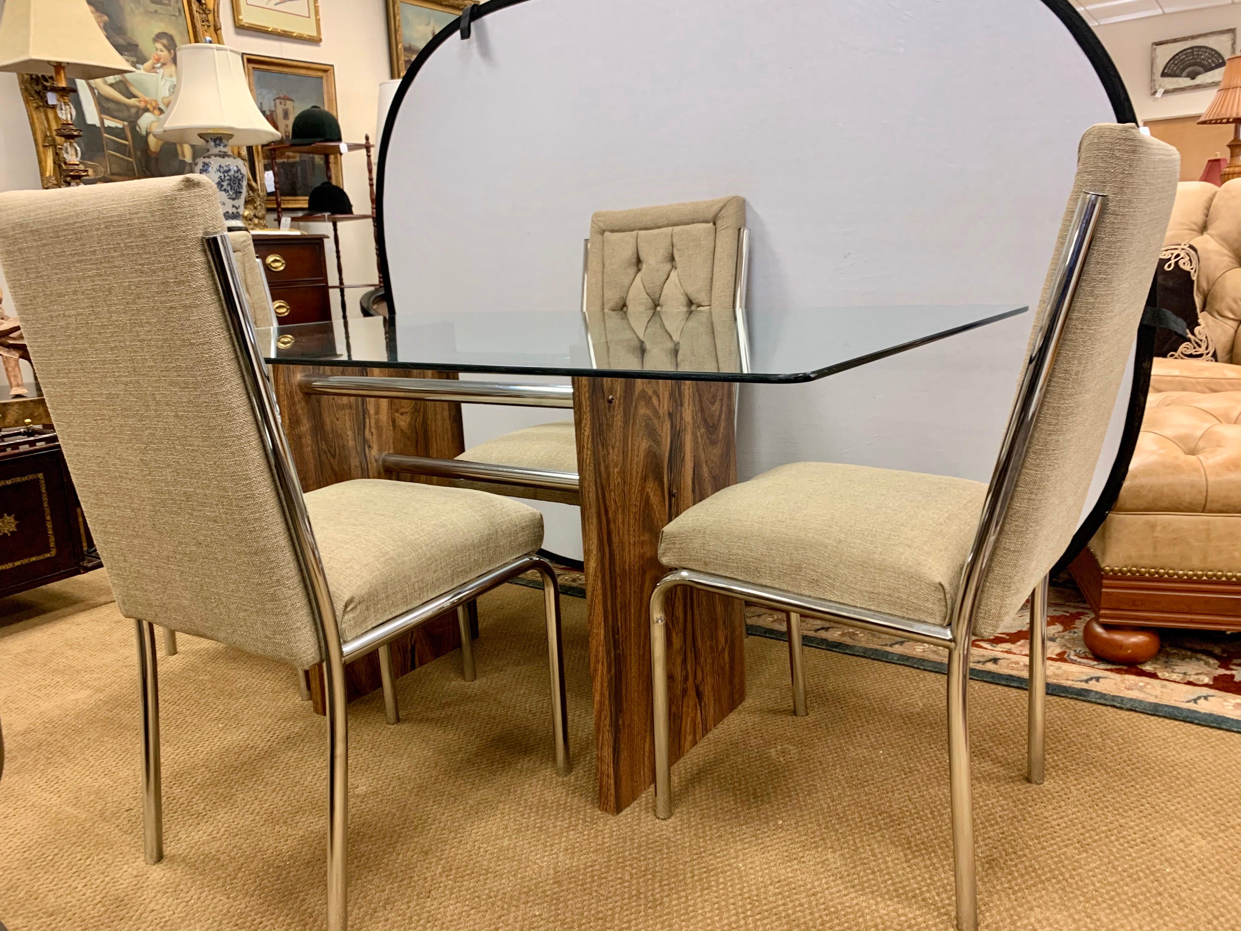 True period piece in the style of Milo Baughman, this glass and rosewood veneered dining table has a great scale, not too big and not too small. It comes with four matching newly upholstered chrome chairs where upholstery is a neutral color that