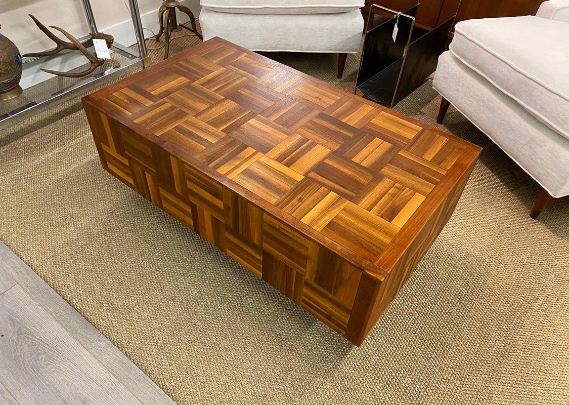 Magnificent brutalist floating cocktail table done in parquet wood. The top of the table is pristine, however there is wear on the base, see pics, circa 1970s and rectangular in shape. 